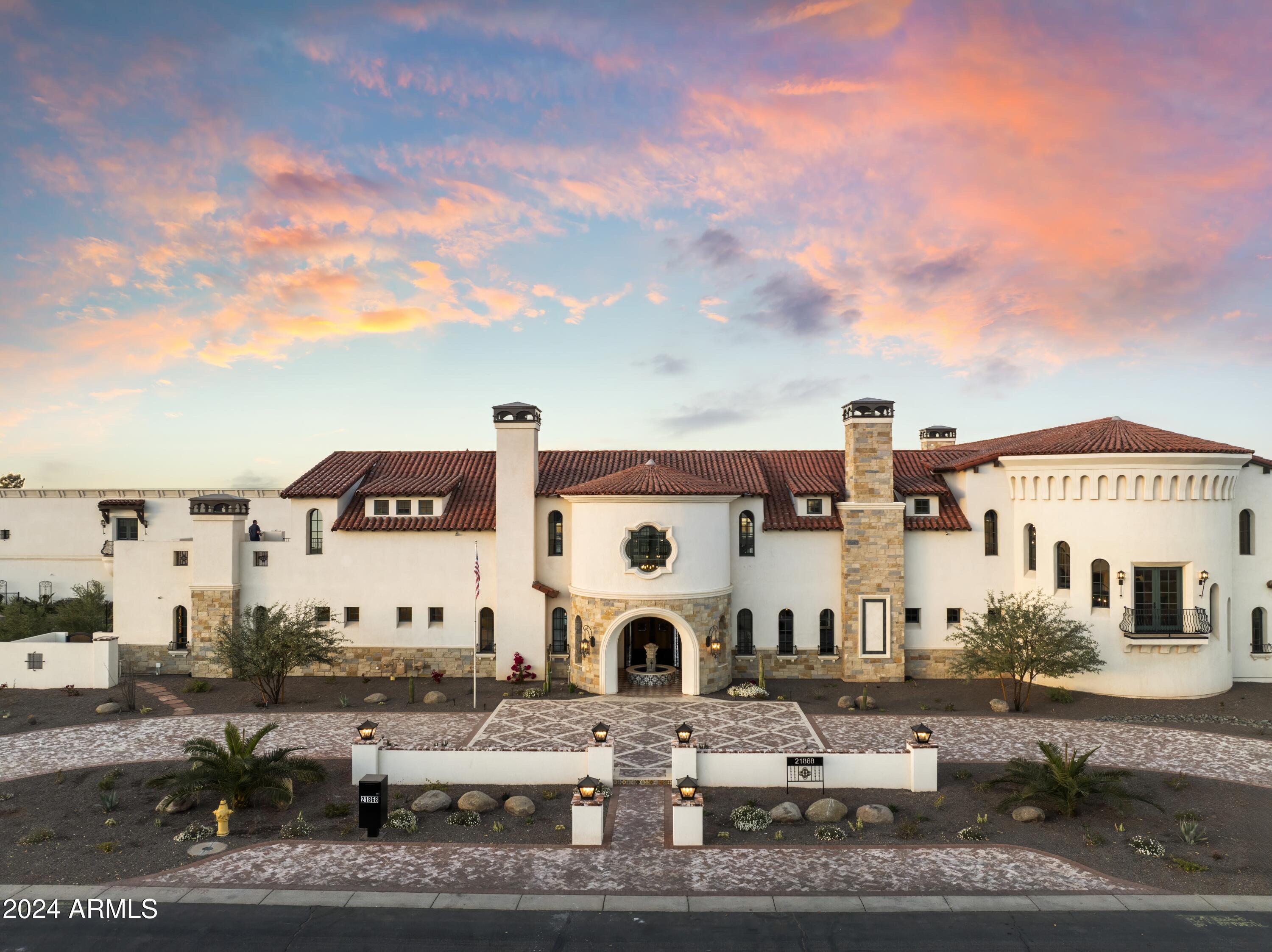 Introducing Misión Veintidós (Mission Twenty-two). This amazing Pegasus Airpark
(5AZ3), Queen Creek, AZ home was inspired by classic Spanish style mission
architecture. The unique mission style entrance to the home is through a breezeway
gate which leads you to a stunning courtyard view of the estate. This estate of 32,000
sq ft of luxury living, with an incredible 26,000+ sq ft of conditioned space has 16'' thick
walls for style and maximum efficiency. Perfectly situated on North South double lot,
taking a massive 350' of taxiway, sits the main residence on three levels and includes
all these features: A 10,000 sq ft steel construction Hangar with Full HVAC, Epoxy coated floor, ''Big Ass''
Fan, Pocket style main hangar doors with an 78'x17' clear opening. Flight office, Storage room, Downstairs bathroom, Interior stairs to mezzanine with bar, Upstairs bathroom, Balcony, Two motorized vertical opening 20 ft glass garage style doors facing the courtyard. " A massive courtyard featuring: 2,000 feet of covered breezeways, Multiple swimming pools with fountains and firepots, Covered outdoor full kitchen under a mission style bell tower, Lit Pickle ball/basketball sports court & Putting green, Sand Volleyball court. "The main house has a 5,000 sq ft Basement: bowling alley, 75 ft shooting range, Tiger Woods' (Full Swing Pro 2.0) Golf Simulator, Wine Cellar, Walk-in vault, Storage room, Bathroom, Interior and exterior stairs. " Next is a 2000+ sq ft detached Master Bedroom: Custom his and her walk-in closets, Separate bathrooms and linens, Large walk-in shower & separate tub, Incredible ceiling details with accent lighting, Multiple balconies, Bar, Fireplace, sliding doors. " Master Spanish Garden: with water and fire features. " General Design considerations: 16" double insulated walls which are quieter, more energy efficient and style correct as seen in the deep-set windows and doors, The extensive iron work is amazing, Custom railing with HH monogram, windows with iron details. " Don't miss these details: clear view elevator from basement to second story sized for wheelchair access. " Wired Cameras access from internet. " Automated lighting. " Security System " Hidden AV closet " Luxury full-service guest suites with spa like bathrooms, suites include laundry and bar in each " 2834 sq ft 2nd Story with Gym, spa and sauna, gym bathrooms & laundry. " Large outdoor balcony, firepit, incredible views of the Superstition and San Tan mountains " Balcony sliding windows overlooking the courtyard. " Firepole slide down from gym to first floor hidden door " Formal living room " 30' sliding glass doors with view of hangar " 28' ceiling with massive beams " Oversize castle style fireplace " Gourmet kitchen with Baking center " Sub Zero Wolf appliances, Easy access from vehicle to kitchen, Fully equipped Butler's Pantry. Dark and smokey (informal sitting room) " Floor level gas fireplace " Full bar " Bathroom " Large sliding window overlooking courtyard pool. Too many features to list.