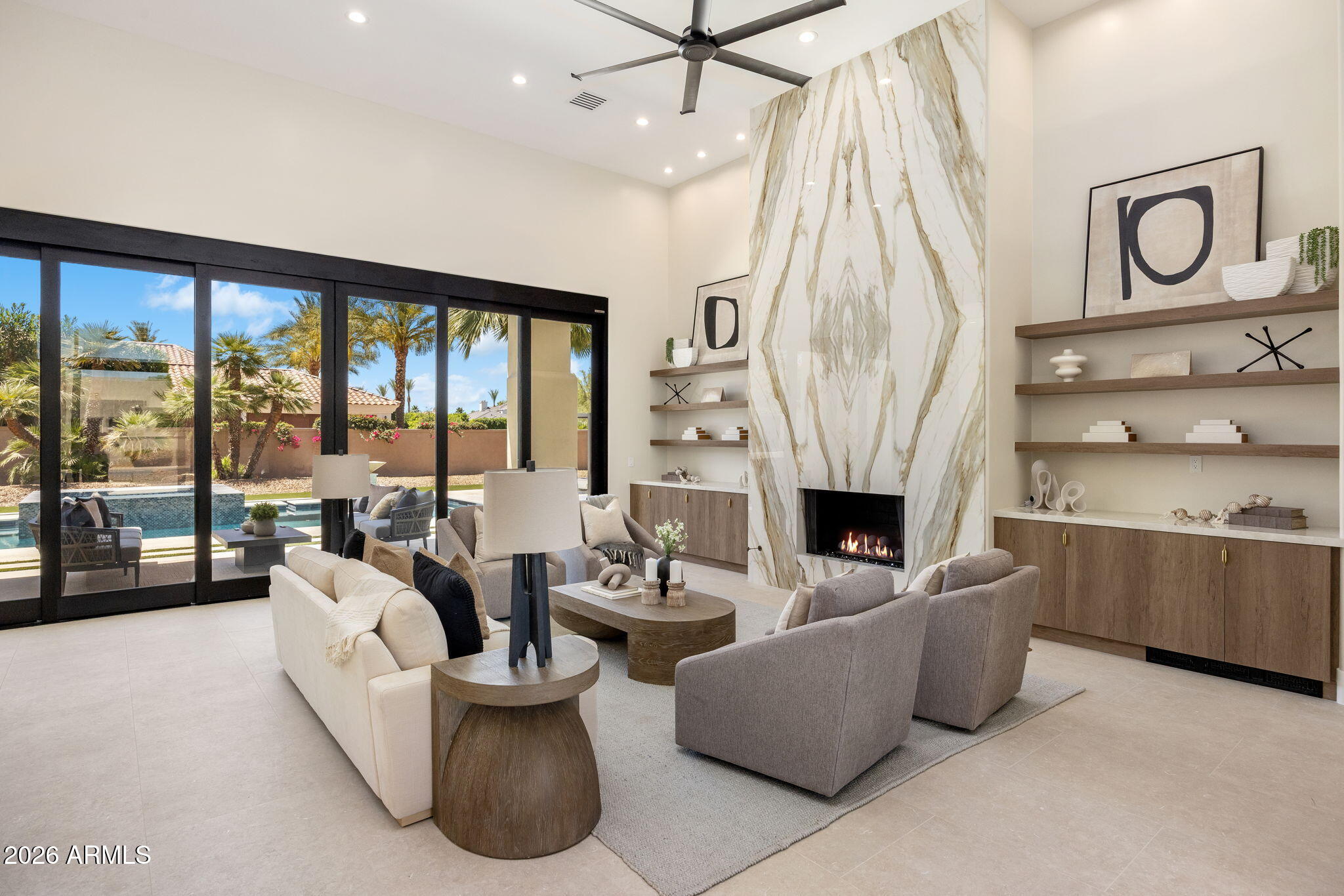Exquisite single-level modern estate in guard-gated Cheney Estates, Paradise Valley. Fully renovated 5,009 SF, 5 bed, 4.5 bath designed for luxury living. Circular driveway framed by 7 mature palms sets a striking arrival. Interior features 22 imported quartzite slabs, 2 dramatic floor-to-ceiling porcelain feature walls, Lutron system, wet bar, hidden butler's pantry, dual dishwashers, and Wolf & Sub-Zero appliances. Motorized pocket doors create seamless indoor-outdoor living. Spa-inspired primary suite offers soaking tub, coffee bar, refrigerator, dual designer closets with private laundry, and separate water closets. Resort grounds include a new construction pool w/ elevated spa, outdoor cooking station, fireplace & TV, putting green, w/ serene spaces for elevated family living.