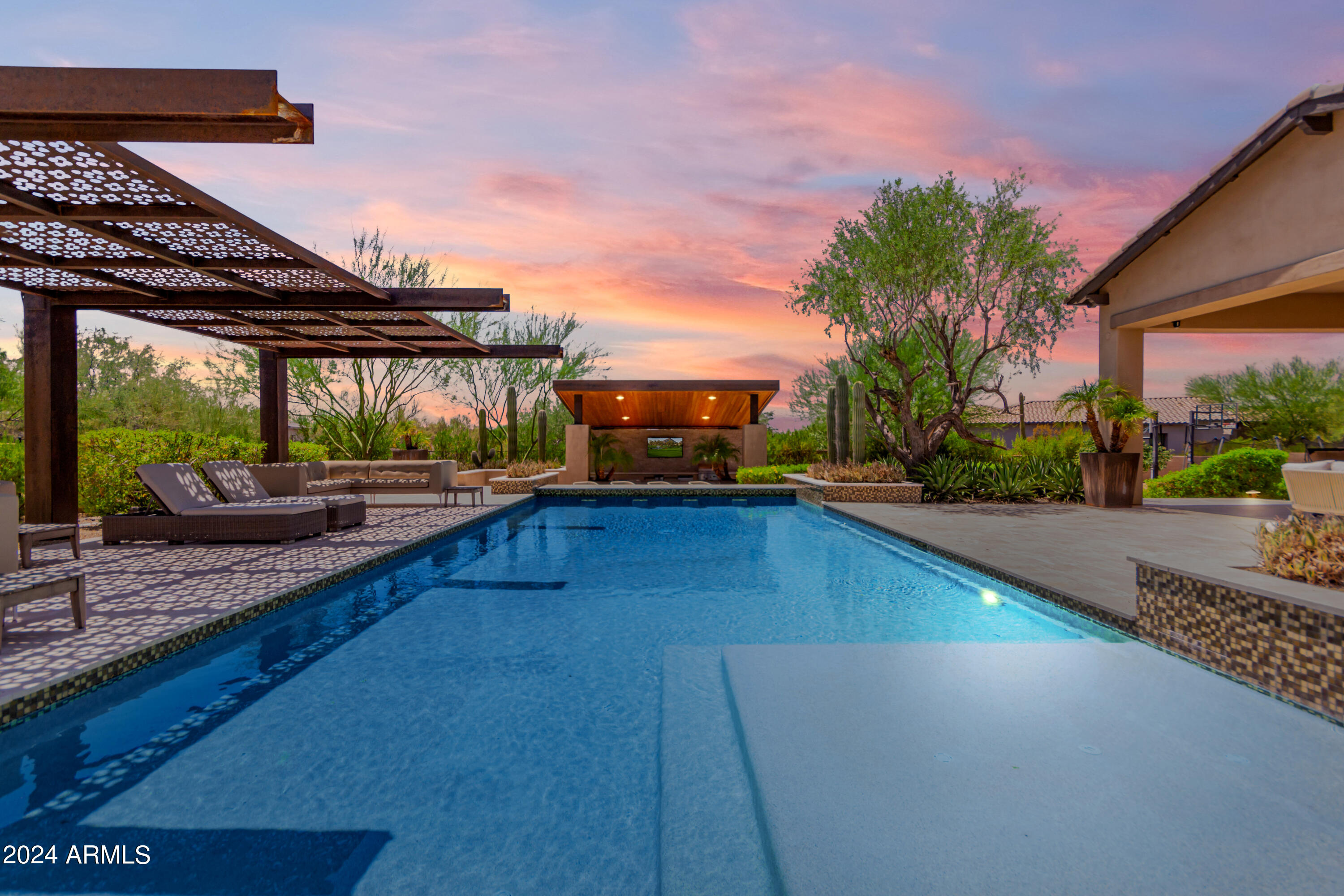 WOW! Just WOW! Nestled on a sprawling 1.882-acre cul-de-sac lot within the prestigious Turquesa Equestrian Estates, this majestic property offers a serene desert oasis. The residence greets visitors with a beautifully landscaped desert yard, enhanced by stone accents on the facade, a spacious 4-car garage, and extensive parking spaces. A large, inviting courtyard offers the perfect spot for enjoying morning coffee in tranquility. Step inside to discover a stunning interior adorned with wood floors and pre-wired surround sound, creating an ambiance of both luxury and comfort. The expansive living and dining area features a cozy fireplace and glass doors that seamlessly blend indoor and outdoor living... The bright great room is an ideal setting for creating cherished memories with loved ones. The sleek kitchen is a chef's dream, equipped with stainless steel appliances, dual wall ovens, granite counters, a mosaic tile backsplash, a walk-in pantry, and two large center islands. A dedicated room with built-in wine racks adds a touch of sophistication, perfect for the connoisseur. Retire to the rich main suite, which offers direct backyard access and a lavish bathroom complete with dual vanities, a standalone tub, a makeup vanity, and a spacious walk-in closet. Additional living spaces include a cozy den accessed through double doors, and two bonus rooms that can serve as a media center or additional bedrooms. Outside, the expansive backyard is a private paradise, featuring a covered patio, built-in BBQ, gazebo, refreshing spa, sparkling pool, lush grassy areas, and a captivating water feature, all set against a backdrop perfect for a variety of outdoor activities. This property is more than just a home, it's a lifestyle. Don't miss the opportunity to experience the grandeur for yourself!