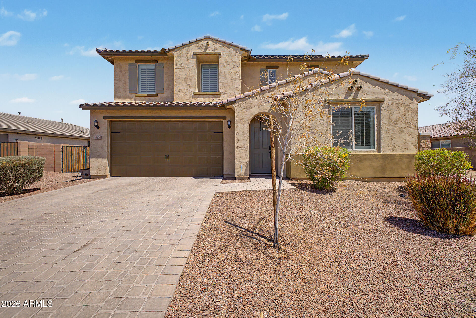 Located in the highly desired Las Brisas, this stunning two-story home offers the perfect blend of luxury, space, efficiency, and functionality. Featuring 5 bedrooms, 3.5 bathrooms, a spacious loft, and a 3-car tandem garage. This home was designed for both comfortable living and entertaining. The open-concept floor plan showcases laminate flooring throughout the main level, granite countertops throughout the home and window shutters for a clean and upscale finish. A gourmet kitchen complete with a gas cooktop stove, kitchen island, wall ovens, and a built-in microwave for a true chef-inspired experience.  The spacious primary suite is conveniently located on the main floor and features his and her closets, dual vanities, and a separate tub and shower. Upstairs offers generously sized secondary bedrooms, a large loft, a Jack and Jill bathroom with dual vanities, and an upstairs laundry room for added convenience. Additional features include two AC units and a Tesla charger.  An extended patio door leads to a fully landscaped backyard with easy maintenance synthetic grass complete with a beautiful sparkling pool. Creating the perfect setting for relaxing or entertaining guests. This energy-efficient home also includes solar, helping reduce utility costs while adding long-term value. With modern upgrades, ample storage, RV parking capability, and thoughtful design throughout, this home truly checks all the boxes. Professional photos coming soon.
