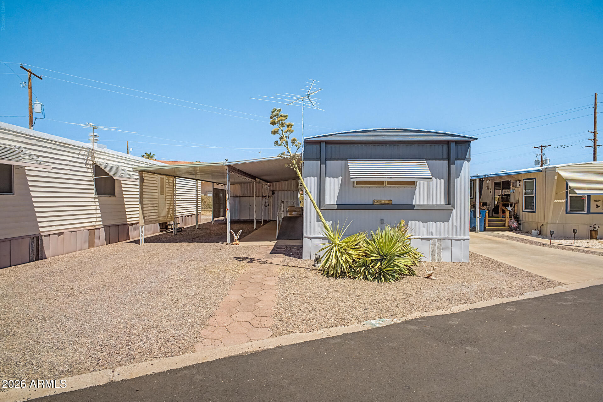 Welcome to The Palms! This charming 3-bedroom, 2-bath manufactured home offers comfortable living with endless potential to make it your own. Featuring a wheelchair-accessible ramp, additional outdoor storage, and a functional floor plan, it's a great opportunity for buyers looking to add their personal style. Residents enjoy access to amenities at both The Palms and neighboring White Sands, including a sparkling pool, pickleball courts, shuffleboard, and a community center with activities year-round. Conveniently located near shopping, dining, golf courses, scenic hiking trails, and the breathtaking Lost Dutchman State Park, you'll love the combination of affordability, recreation, and Arizona lifestyle this home has to offer!