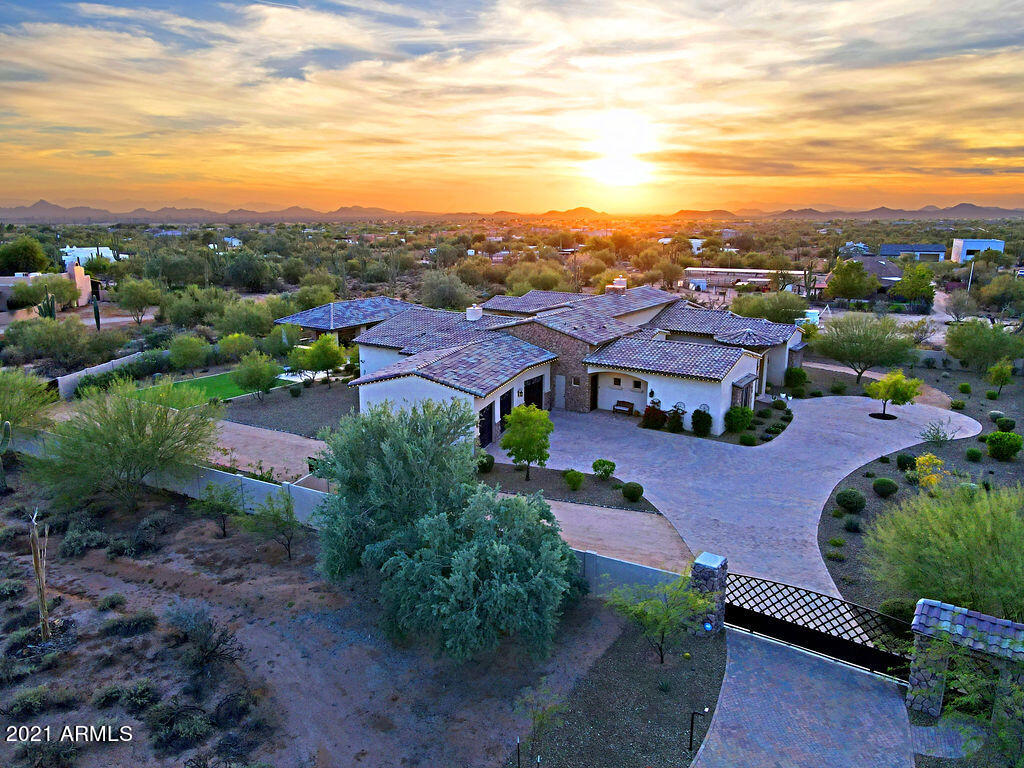 Sophistication with unparalleled construction in this unique and very private Estate on a prime 2.5 acre parcel in North Scottsdale. 5+ large bedrooms, 5.5 bathrooms, theater room with a 80'' TV, exercise room, casita/pool suite, 4 fireplaces. This home has it all. No HOA, All on one level, low taxes $5101 for 2021.Be ready to take a tour of this energy efficient and luxurious property.5669 Sq. ft. with 11,000 Sq. ft. under roof. 3 tier/360 degree negative edge heated pool with Spa, Ramada with Full Kitchen and large screen TV and views of Pinnacle Peak. Automatic gated property entrance with block wall and hand forged metal accents. Hand forged Iron and Glass doors adorn the exterior exits throughout. Bonus room attached to master (Currently serving as a work out room) could easily be converted to a 6th bedroom. 12'-18' ceiling throughout. Versaliie pattern Travertine with 4" stone baseboards in all main areas