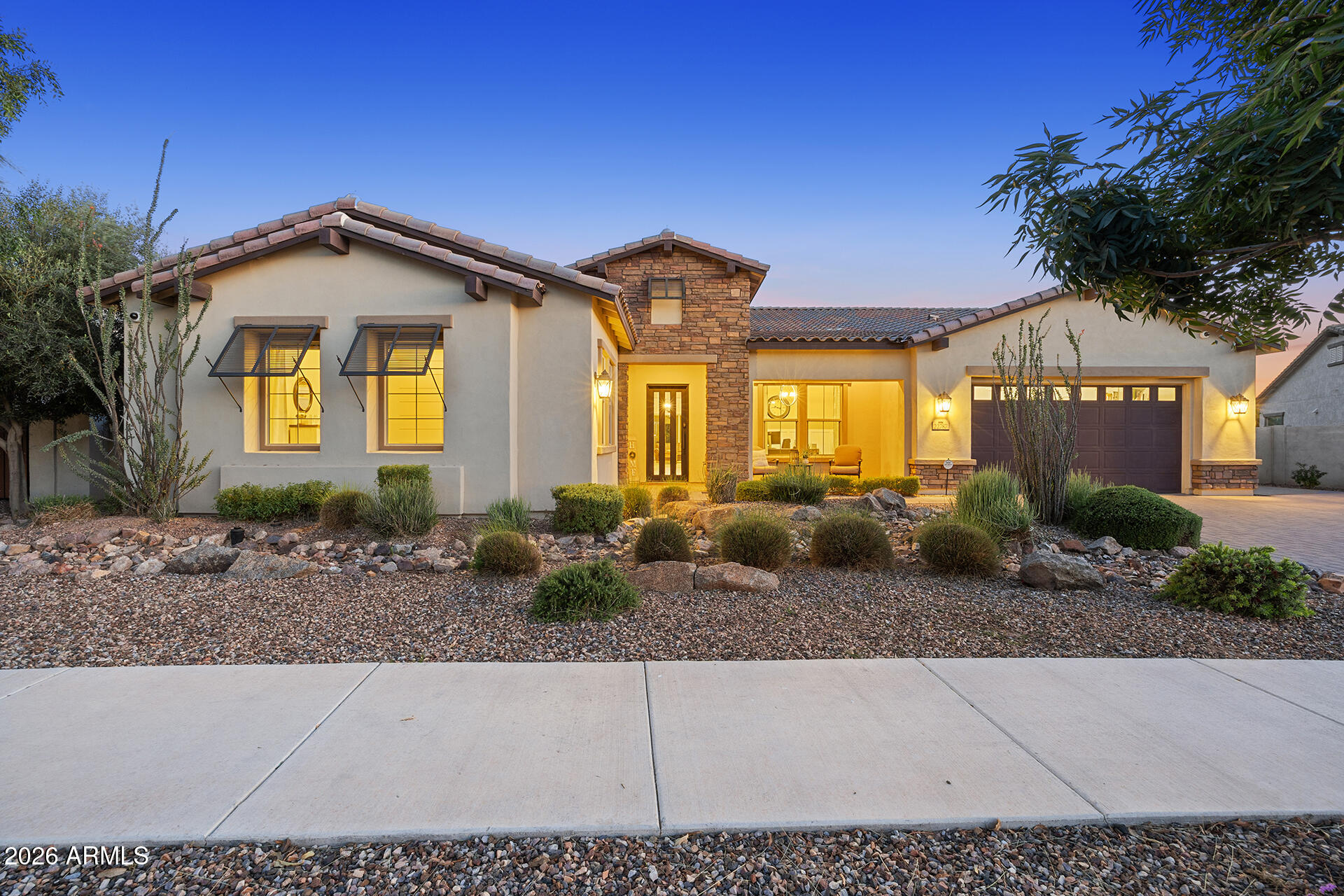 This stunning 4-bedroom, 3.5-bathroom luxury home in an exclusive gated community offers elegance and comfort on a sprawling 14,783 sq. ft. lot with breathtaking panoramic views. A former model home with $200K in extensive upgrades, it features a den, great room, and an attached casita-perfect as a multi-generational suite with its own kitchenette and laundry area with cabinets and a sink. The exterior showcases incredible curb appeal with an iron entry door, while the elegant interior impresses with two-tone accent walls, high ceilings, and an airy, inviting atmosphere. The gourmet kitchen is a chef's dream, featuring granite counters, a walk-in pantry, a large island, and both formal and casual dining areas, including a breakfast bar. Spectacular zero-corner sliding glass doors create seamless indoor-outdoor living! Step outside to a covered patio overlooking the beautifully designed backyard with a private pool, paver pathways, and lush landscaping. The spacious 3 car garage provides ample room for vehicles, storage, or a workshop, adding to the home's practicality. Plus, the driveway has been recently extended with pavers and an RV gate has been added! Community amenities include a playground, pool, and more, making this home the perfect blend of luxury and convenience!
