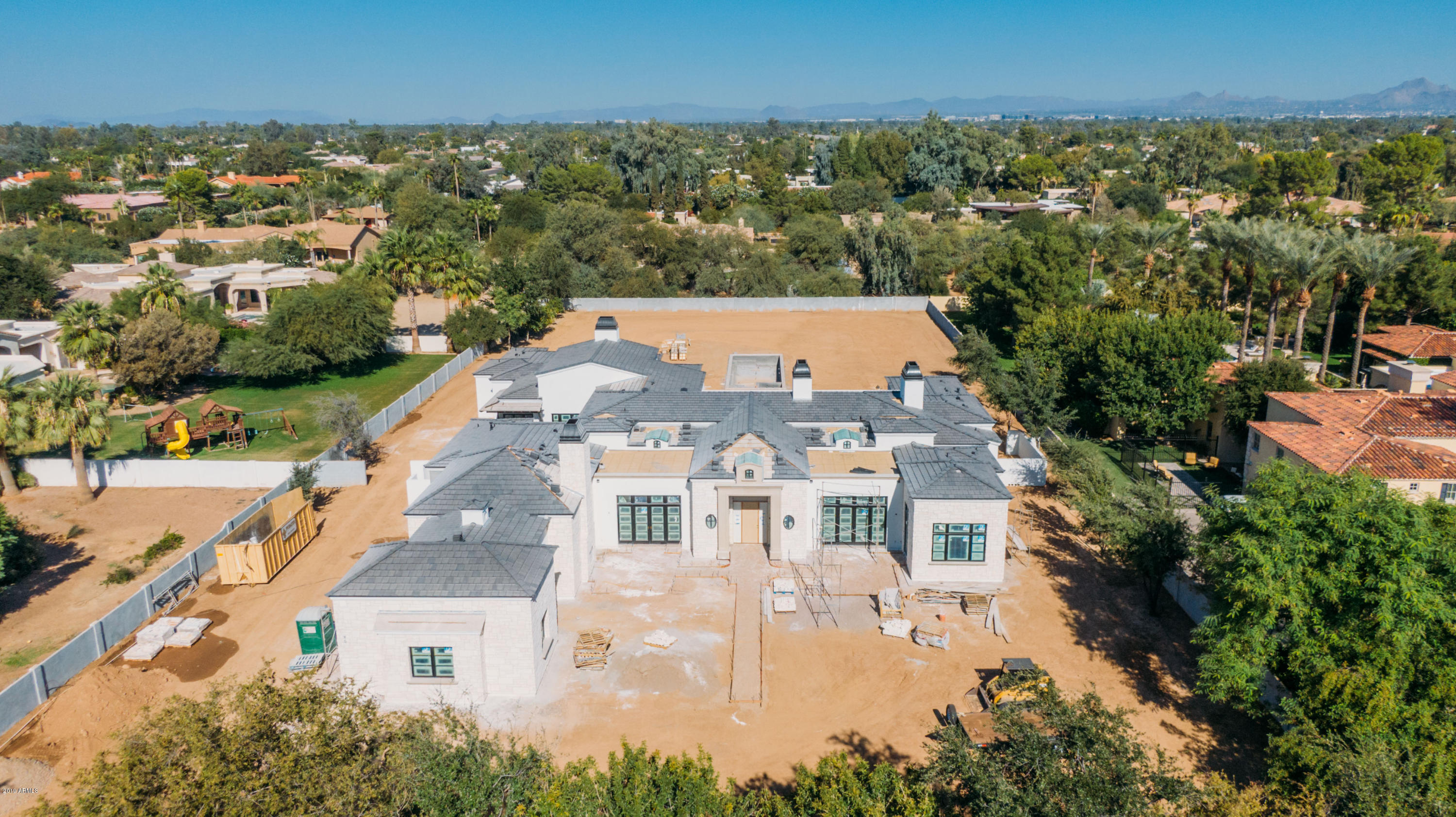 Brand new FRENCH COUNTRY estate currently under construction on a rare 1.5 ACRE LOT situated on a quiet cul-de-sac street in the heart of Paradise Valley. A collaboration between Candelaria Design, Argue Custom Homes, Hasbrook Interiors, and Refined Gardens, this must-see GATED and completely walled masterpiece offers an exclusive and private setting. A modern take on this traditional architectural style mixes timeless exterior features with a clean, crisp, refined yet comfortable interior. Stone and stucco façade with limestone accents. Numerous rooms open to quaint courtyards or covered patios. Enjoy lush landscaping, MATURE TREES, an oversized pool, spa and an EXPANSIVE BACKYARD that offers endless options. Estimated completion: February 2020. Cove, coffered, and groin vault ceilings, reclaimed wood beams, wood floors, marble master bathroom finishes, stone and porcelain secondary bathroom finishes, and a Wolf/Subzero appliance package highlight some of the impressive interior design elements and amenities.  The great room features a generous bar offering indoor/outdoor seating and entertaining with its own adjoining courtyard. The kitchen offers a spacious prep kitchen/butler's pantry as well as a generous and sunny breakfast room. Other highlights of this sophisticated floor plan include: a kids'/guest wing offering 3 bedrooms with ensuite bathrooms and walk in closets; his and hers master closets; his and hers toilet rooms; a mud room; 3 interior fireplaces (living room, family room and master bedroom) and an exterior fireplace in the front courtyard. Tall hedges line the front of the property, creating immediate natural privacy.  This masterpiece was designed with the ultimate entertainer in mind. Hurry - this phenomenal custom estate won't last!  Estimated completion: February 2020.