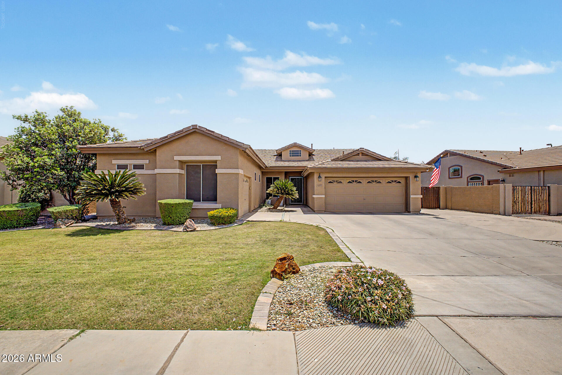 Hard-to-find single level Gilbert home with a 3 car garage, updated kitchen, and major system upgrades already completed. This 3 bedroom, 2 bathroom home offers a functional split floor plan with an open-concept layout connecting the living, dining, and kitchen areas--ideal for everyday living and entertaining. Fresh interior paint and natural light give the home a bright, clean feel throughout, with shade screens on the windows to optimize the home's interior against the desert heat. The kitchen is a standout feature, offering granite countertops, stainless steel appliances, extensive cabinetry, and a rare double island that adds both workspace and seating. The primary suite is privately located and includes a walk-in closet and an en-suite bath with updated finishes. A separate den provides flexibility for a home office, guest space, or additional living area. Major updates include a BRAND NEW roof with a 30-year warranty, a 2023 main AC unit, and a newer water heater, offering long-term peace of mind. The backyard is designed for usability and privacy, featuring a full-width covered patio, grassy area, mature fruit trees (orange and blood orange), and extra side yard space. Surrounded by single-story homes, the setting feels more open and private. Located in a well-established Gilbert neighborhood near parks, shopping, dining, and freeway access, this home combines a desirable layout, key upgrades, and plenty of storage throughout the home and garage.