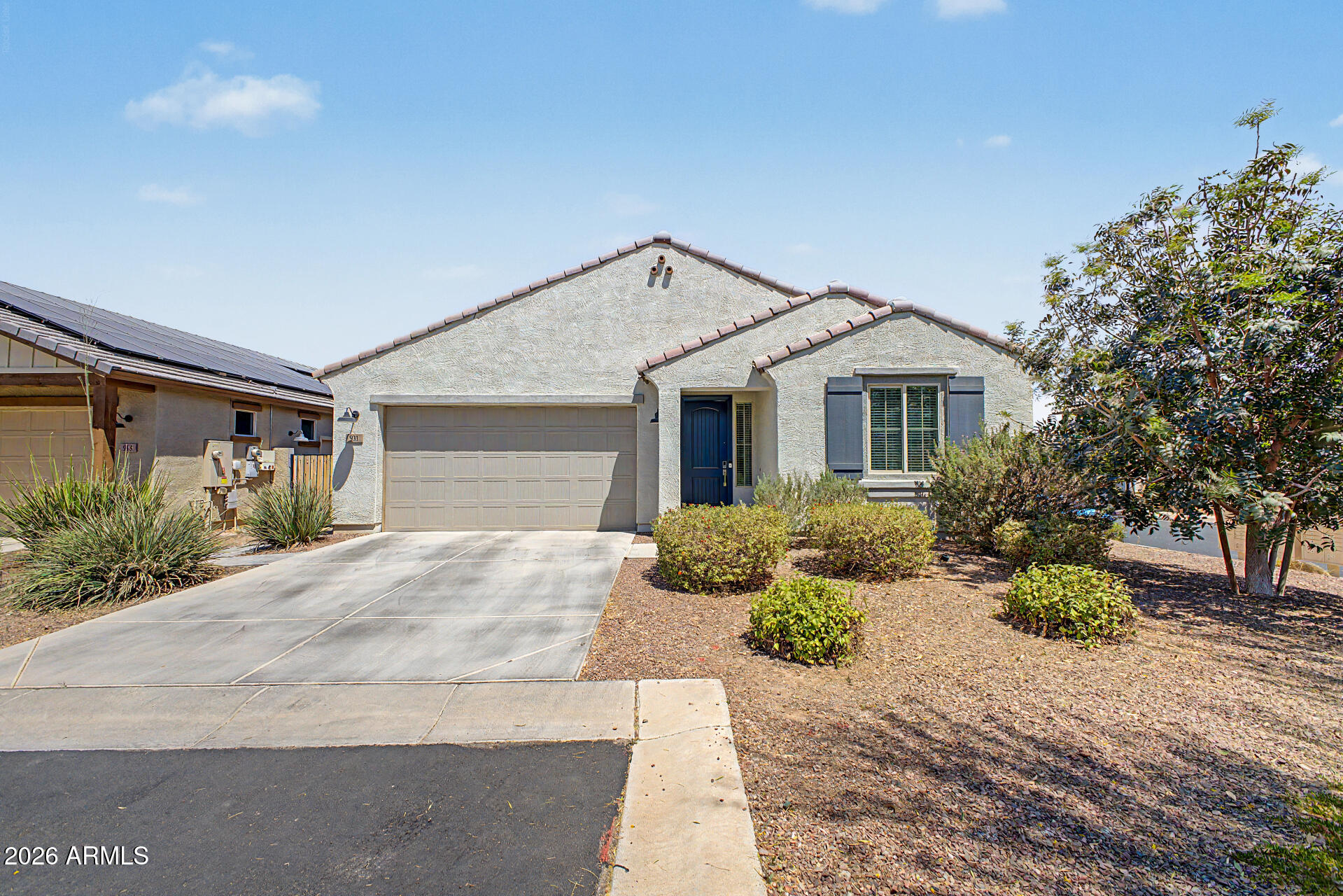 You'll love this charming home in the desirable Centerra community! Situated on a corner lot, this 3 bed, 2 bath home features a 2-car garage, manicured landscaping, wood-look tile flooring, plush carpet in bedrooms, recessed lighting, & abundant natural light. The open-concept layout is perfect for entertaining and flows into a beautiful kitchen with stainless steel appliances, quartz countertops, subway tile backsplash, white shaker cabinets with crown molding, walk-in pantry, & a large island with breakfast bar seating. The spacious primary suite offers dual sinks & a walk-in closet. Enjoy the low-maintenance backyard w/ a covered paver patio, artificial turf, and mini putting green. Beautiful Community pool nearby plus close to Goodyear Ballpark and Tres Rios Golf Course! Welcome home!