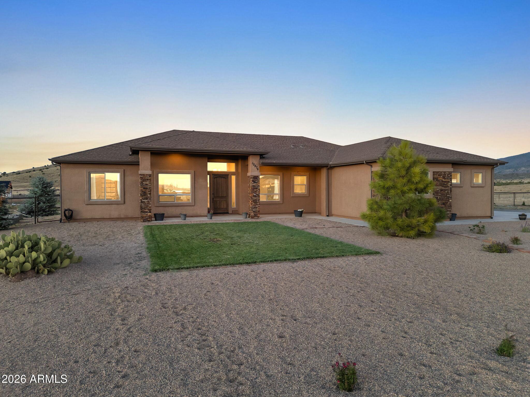 Welcome to your dream home! This beautiful residence sits on 2 peaceful acres bordering State Land, offering privacy, space, & stunning natural views. Featuring 3 bedrooms, 2 bathrooms, office, a versatile flex space, & oversized 3-car garage, this home has room for everyone. The open-concept great room showcases a corner stacked-stone gas fireplace, perfect for cozy evenings. The chef's kitchen is complete w/knotty alder cabinetry under-cabinet lighting, granite countertops, glass tile backsplash, large island w/sink, LG appliances & pantry for ample storage. Enjoy the split floor plan w/spacious primary suite offering patio access. The primary bath includes dual vanities, walk-in shower, soaking tub, & expansive walk-in closet. Relax & take in the gorgeous sunsets from the  back patio.