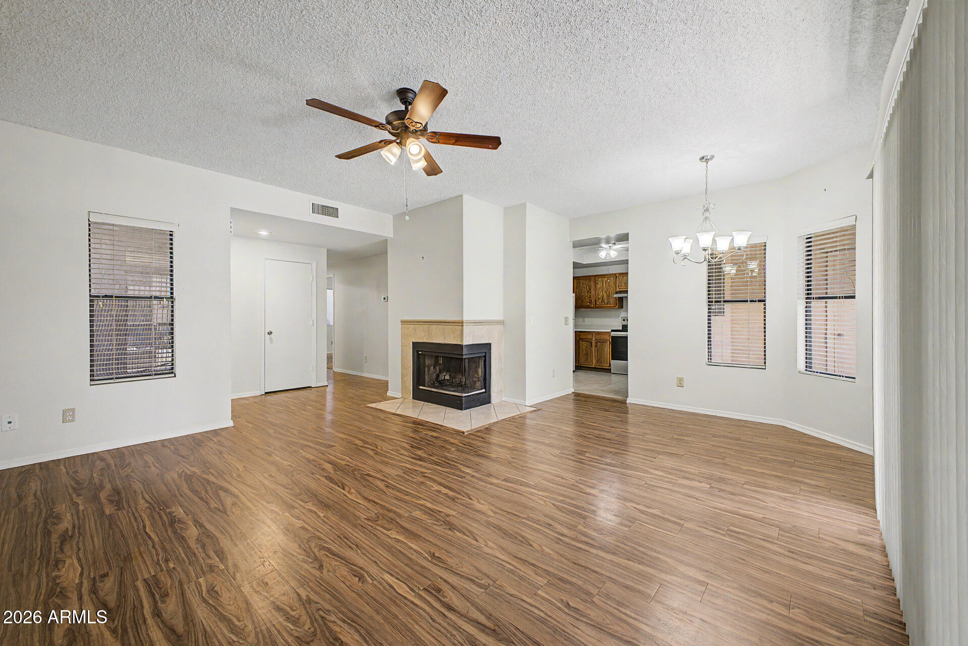 Welcome to this well-maintained 2 bedroom, 2 bath single-story lower-level condo offering comfort, convenience, and thoughtful updates throughout. Fresh newer paint, newer carpet in the bedrooms, and newer vinyl flooring in the main living areas create a clean, modern feel. The open living and dining area is anchored by a cozy fireplace and flows seamlessly to a large covered patio with an attached exterior storage closet--perfect for relaxing or entertaining.The kitchen includes a newer range and refrigerator, while the recently replaced HVAC system adds peace of mind. Indoor laundry hookups provide everyday convenience. The spacious primary suite features abundant closet space, a large vanity area, and a private bath. A second bedroom and full hall bath offer flexibility for guests, roommates, or a home office. Completing the home is a detached 1-car garage for added storage and parking.