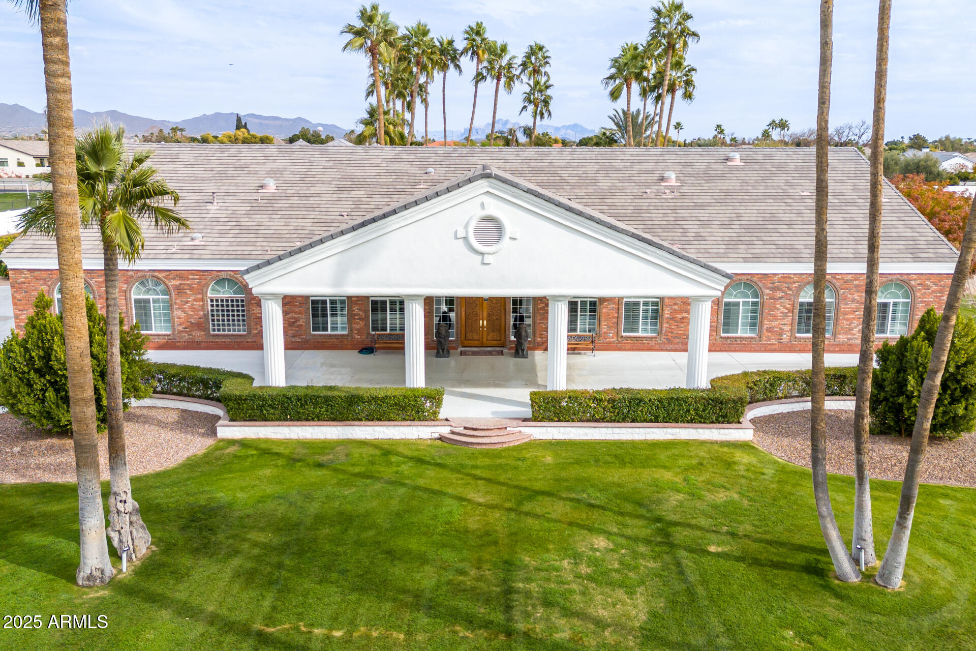BACK AVAILABLE! NOT FOR LONG! This is an extremely rare opportunity to own nearly 7 acres of prime land in one of Mesa's most sought after locations. Large parcels like this simply don't come available often. Offering expansive space and endless potential, this impeccably maintained property is the perfect canvas for your custom estate. Fully gated circular drive with lush lawns, beautifully manicured landscape, &  a porte-cochere welcomes you to your private sanctuary. This home exudes elegance with the highest quality of custom finishes throughout. Main home is 5,693 sqft including 4 bedrooms and 3.5 baths. Kitchen boasts generous eat in area, breakfast bar, dual Bosch dishwashers, double oven & gas cooking.Off the kitchen you will find the custom dining room addition, designed to seat 20 comfortably & seamlessly connect to the kitchen and 2 large living areas. One of the home's most desirable features is the dual primary suites. The main primary suite offers a true retreat with its plush silk carpeting and custom upholstered walls, exuding an unparalleled sense of elegance and comfort. The secondary primary suite provides flexibility for guests or extended family, ensuring everyone has their own private space.
For those who work from home or appreciate a private study, the large office is a standout feature. Featuring exquisite custom cherry millwork, creating a sophisticated and professional setting. Beyond the elegant interior, the residence opens up to a beautifully landscaped outdoor retreat! The spacious backyard features an oversized covered patio and a sparkling diving pool, all enclosed by a charming white iron fence. PLUS! The property includes a vast open area with flat and cleared land, perfect for various uses such as equestrian facilities, recreational space, or even future development.
The 6-car & RV tandem garage is equipped with cabinetry, electric vehicle charging, & fully temperature control, with designated workshop area. For added convenience and versatility, the property also includes a beautiful 1,115 sqft casita. Featuring 2 spacious bedrooms, a full kitchen, bath, laundry & designated 2-car carport. Adding a whole separate living for family, grounds keeper, or house managers. 
Whether you're looking to develop, invest, or simply enjoy the beauty and serenity of this exceptional property, it presents an incredible opportunity in one of Mesa's most desirable areas.