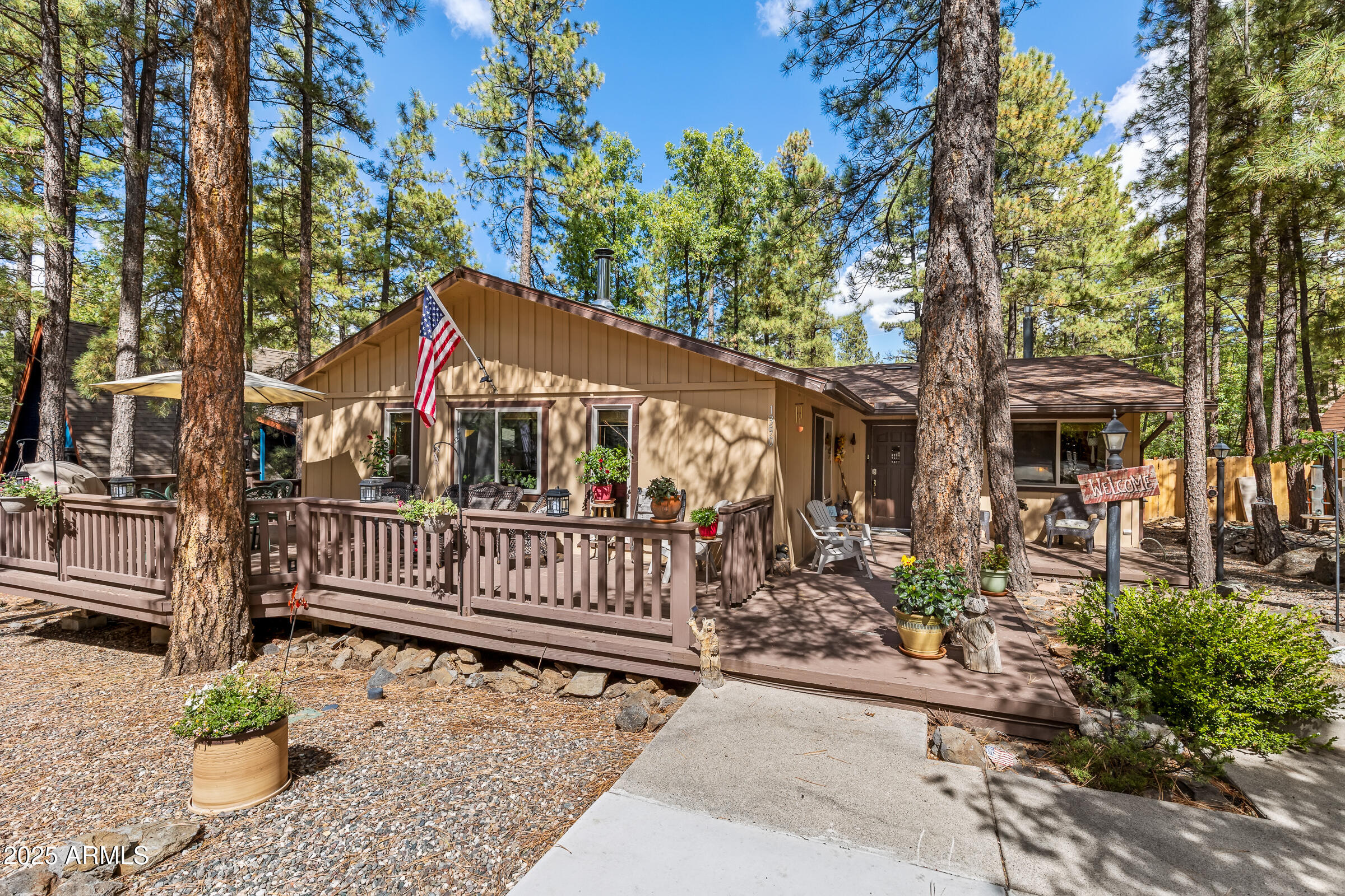 PRICE REDUCED!!! From the moment you arrive, this eye-catching home stands out with its incredible curb appeal, charming wrap-around deck, and inviting spaces made for relaxing and entertaining. Located in the highly desirable ANIMAL HILL neighborhood, this SINGLE-LEVEL home offers FOUR bedrooms, TWO SPACIOUS LIVING AREAS, and an open-concept layout that feels warm, comfortable, and welcoming throughout. The beautifully designed kitchen features abundant counter space, ample cabinetry, and effortless flow into the main living areas. Step outside to enjoy the beautifully landscaped front yard, fully fenced backyard, and covered back porch -- perfect for gatherings or quiet mountain evenings. Major upgrades include a NEW ROOF (2023), top-of-the-line MILGARD WINDOWS (2021), NEW FRIDGE (2024), and NEW WALL HEATER (2025), making this home completely move-in ready. Offered furnished, this property is also an excellent opportunity for a short-term rental or vacation getaway!