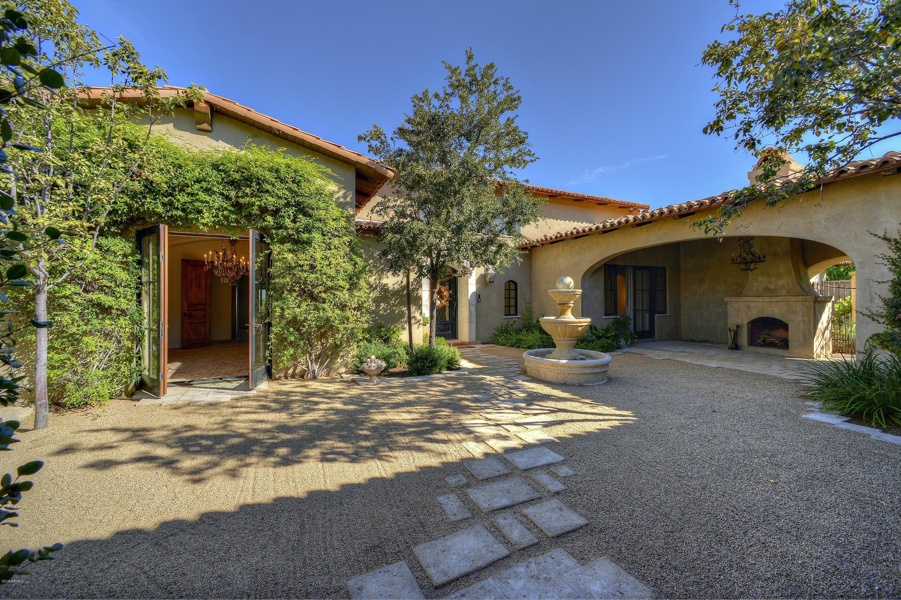 BACK ON THE MARKET!!! The Estate is sited perfectly on the 1.44 acre lot to capture views from many rooms. Front courtyard opens to a large loggia with fireplace and fountain. This is where the romance begins!  French doors from many rooms open to the patios and courtyards. Mature lush landscaping adds to the privacy. Custom tile work with Reclaimed french brick floors and French oak planks keep the mood cohesive. Formal living and dining rooms. Master suite with huge closet and private patio to the massive spa. Designer white Kitchen with beams opens to the wisteria covered patio. Two offices, 3 ensuite bedrooms with additional family room , yummy laundry room and guest casita complete the property.  This is truly a work of living art .