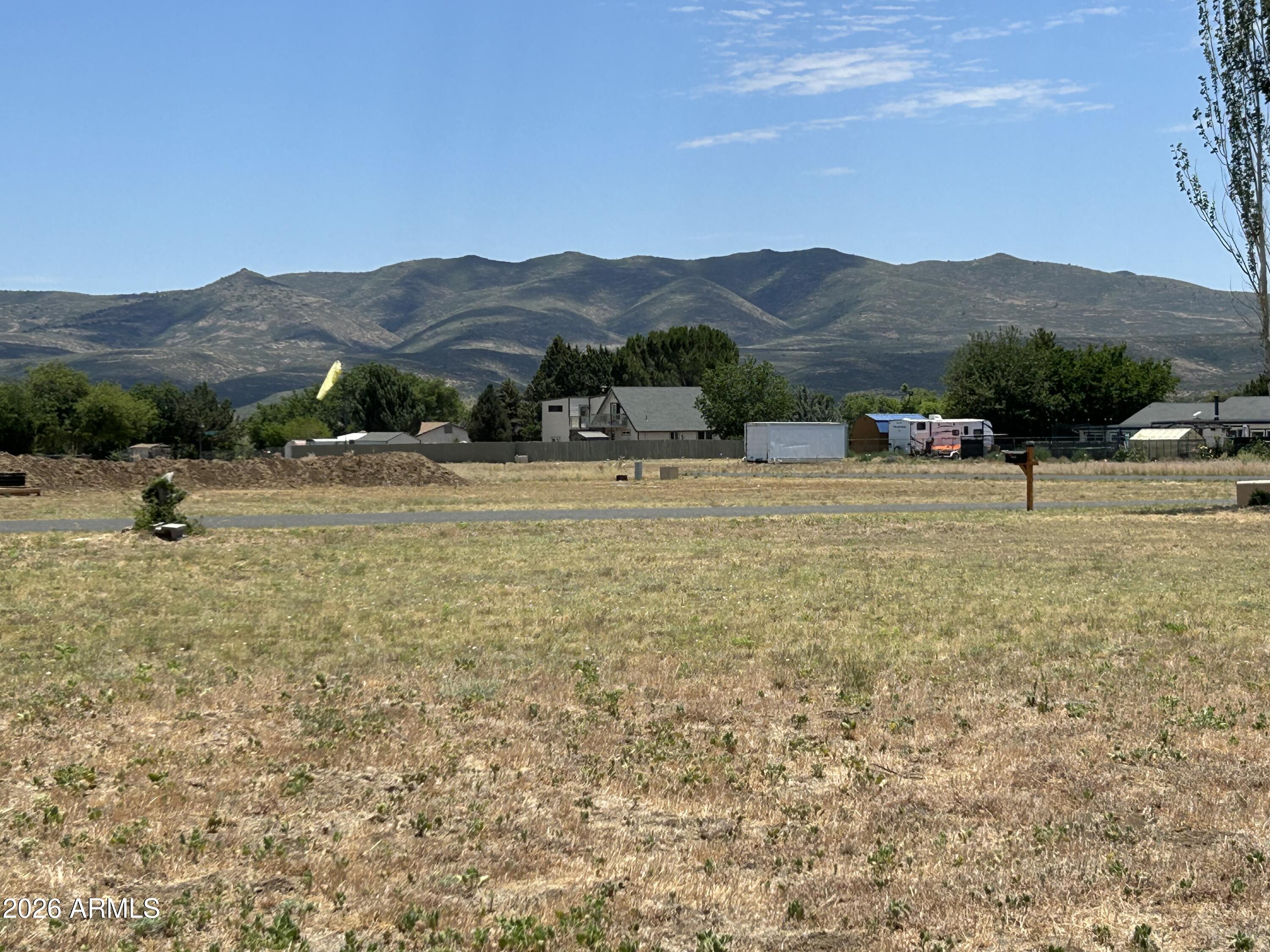 GORGEOUS VIEWS from this LEVEL, USABLE lot. NO HOA! With Water & Electric already IN PLACE, it doesn't get much easier than this! Easy drive to land on paved road from Hwy 89. At .41 beautiful acres, there's lots of room for your home, garage, chickens, greenhouse, etc. Peeples Valley is a hidden gem, boasting 4 mild seasons, blue skies, green trees and fresh mountain air. Just 40 minutes to Wickenburg, 50 minutes to Prescott and 1.5 hours to Phoenix - You're close enough but away from it all!