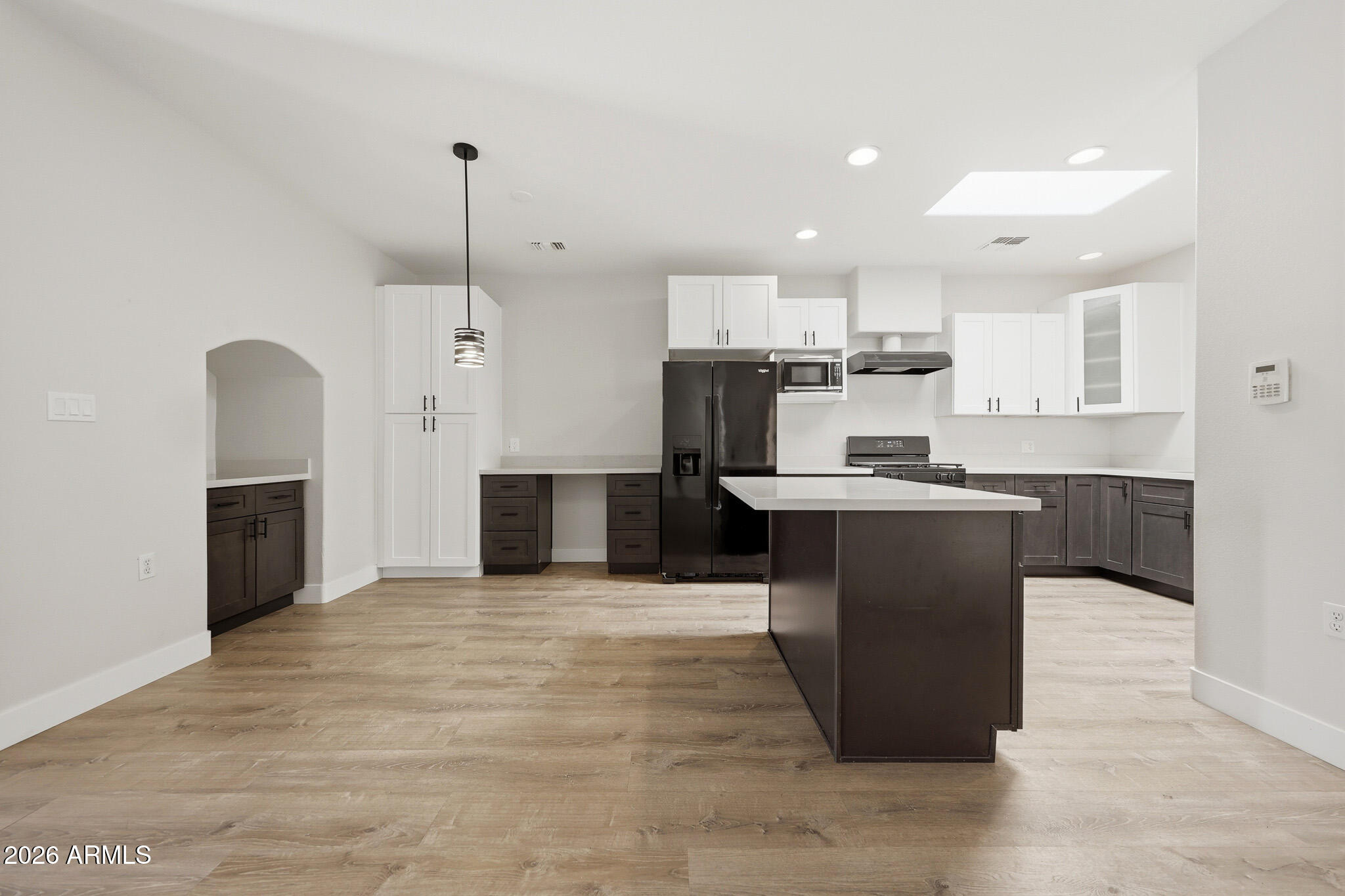 Stylishly updated and turnkey in the heart of sought-after Arcadia Lite. This bright, open-concept home showcases a beautifully remodeled kitchen with white shaker cabinetry, quartz counters, stainless steel appliances, open shelving, and an oversized island ideal for entertaining. Wood-look flooring, updated designer lighting, and a soft neutral palette create a clean, modern aesthetic throughout. Spacious living and dining areas offer great flow and functionality with abundant natural light and storage. Gated community amenities include a resort-style pool. HOA covers exterior maintenance, front landscaping, water, sewer, and trash. Prime location near Arcadia dining, shopping, entertainment, and easy access to the 36th Street corridor. Water heater replaced in 2024