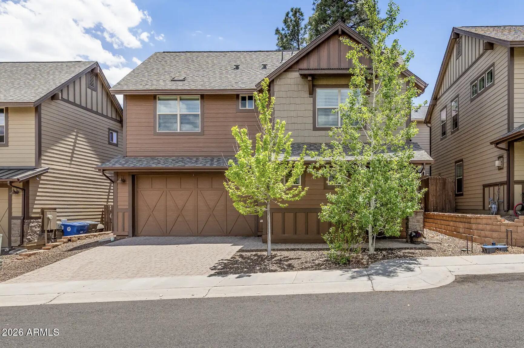 This flawless home features 3 bedrooms and 2.5 bathrooms, along with beautiful upgrades throughout. Standout features include granite countertops, a spacious walk-in closet in the primary suite, low-maintenance front and back yards, and 8-foot sliding glass doors leading to the fully tiled primary walk-in shower. Zoned heating and cooling make it easy to manage upstairs and downstairs temperatures right from your phone, while the instant hot water system helps minimize water waste when washing dishes or starting the shower. Upstairs, a versatile bonus living area offers the ideal space for a quiet home office, a fun kids' play area, or a cozy retreat for teens. AI-generated living room and backyard images provide a glimpse of just one of the many ways these spaces can be personalized. The neighborhood provides multiple parks with swings, basketball courts, and play structures, and the Arboretum, Fort Tuthill, and NAU are only a short drive away.