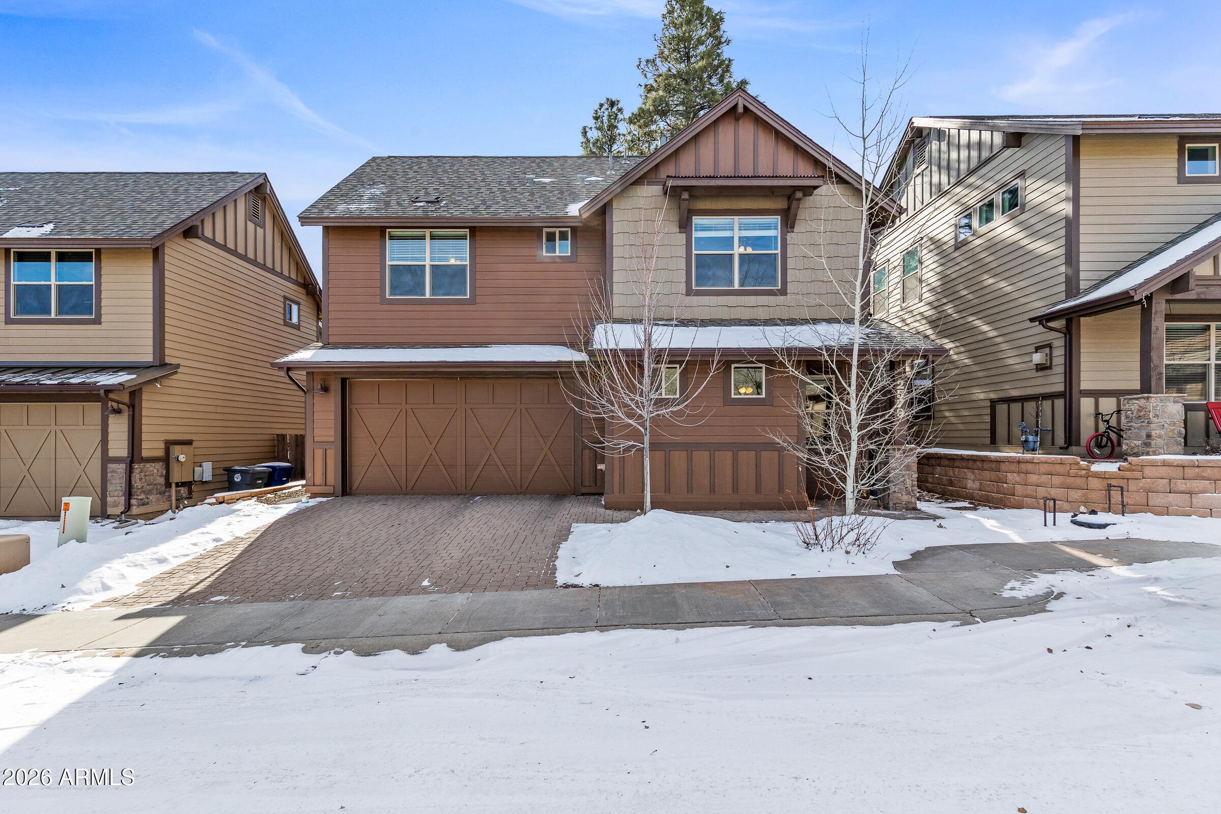 This flawless home features 3 bedrooms and 2.5 bathrooms, along with beautiful upgrades throughout. Standout features include granite countertops, a spacious walk-in closet in the primary suite, low-maintenance front and back yards, and 8-foot sliding glass doors leading to the fully tiled primary walk-in shower. Zoned heating and cooling make it easy to manage upstairs and downstairs temperatures right from your phone, while the instant hot water system helps minimize water waste when washing dishes or starting the shower. Upstairs, a versatile bonus living area offers the ideal space for a quiet home office, a fun kids' play area, or a cozy retreat for teens. AI-generated living room and backyard images provide a glimpse of just one of the many ways these spaces can be personalized. The neighborhood provides multiple parks with swings, basketball courts, and play structures, and the Arboretum, Fort Tuthill, and NAU are only a short drive away.