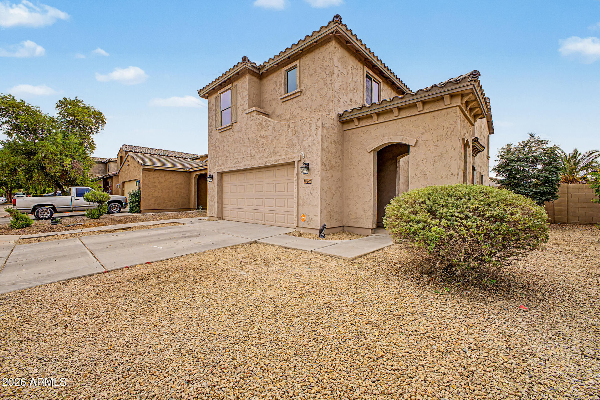 Beautiful 5-bedroom, 3-bath home in the desirable Country Place community of Tolleson, AZ. This move-in-ready home features a spacious open-concept floor plan filled w/ natural light. The well-appointed kitchen offers granite countertops, a copper farmhouse sink, white cabinetry, stainless steel appliances, a kitchen island, and a pantry. A bedroom and full bathroom downstairs. Upstairs, the spacious loft provides additional living or entertainment space. Generously sized bedrooms offer excellent closet storage, while the primary suite creates a private retreat with beautiful mountain views. Pavers & synthetic grass create a modern, functional backyard. Say goodbye to high electric bills! This home features a solar panel system that will be fully paid off by the seller at close of escrow.