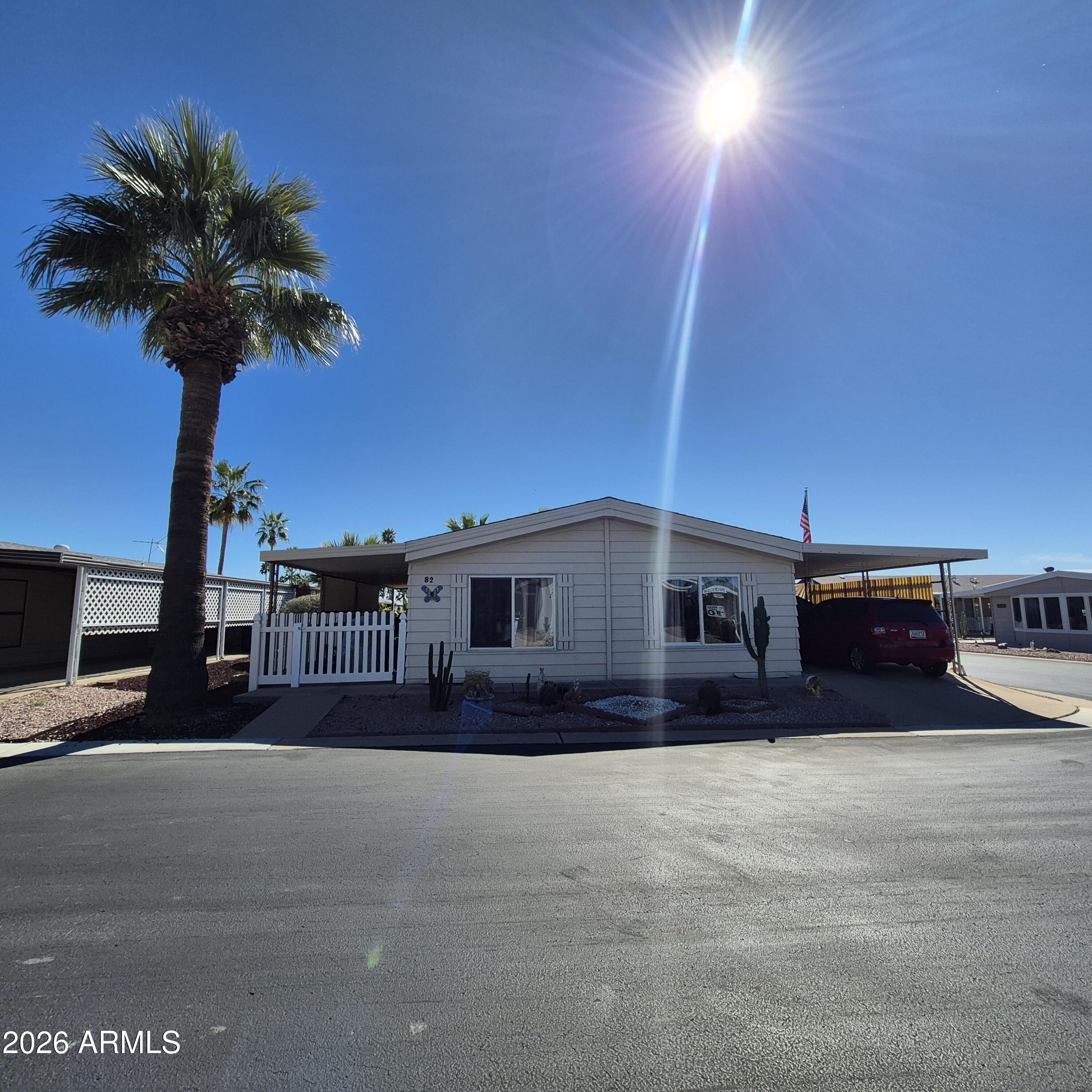Beautiful Double wide at this PRICE! 24x40 double-wide in desirable Holiday Palms 55+ community! This well-maintained 2-bedroom, 2-bath home features a spacious living room, bright kitchen with ample cabinetry, and a generous primary suite with private bath. Enjoy Arizona living on the large covered patio perfect for relaxing or converting into an Arizona room. Includes covered carport, storage shed, and private fenced outdoor space. Holiday Palms offers an active lifestyle with great amenities in a friendly, well-kept community.