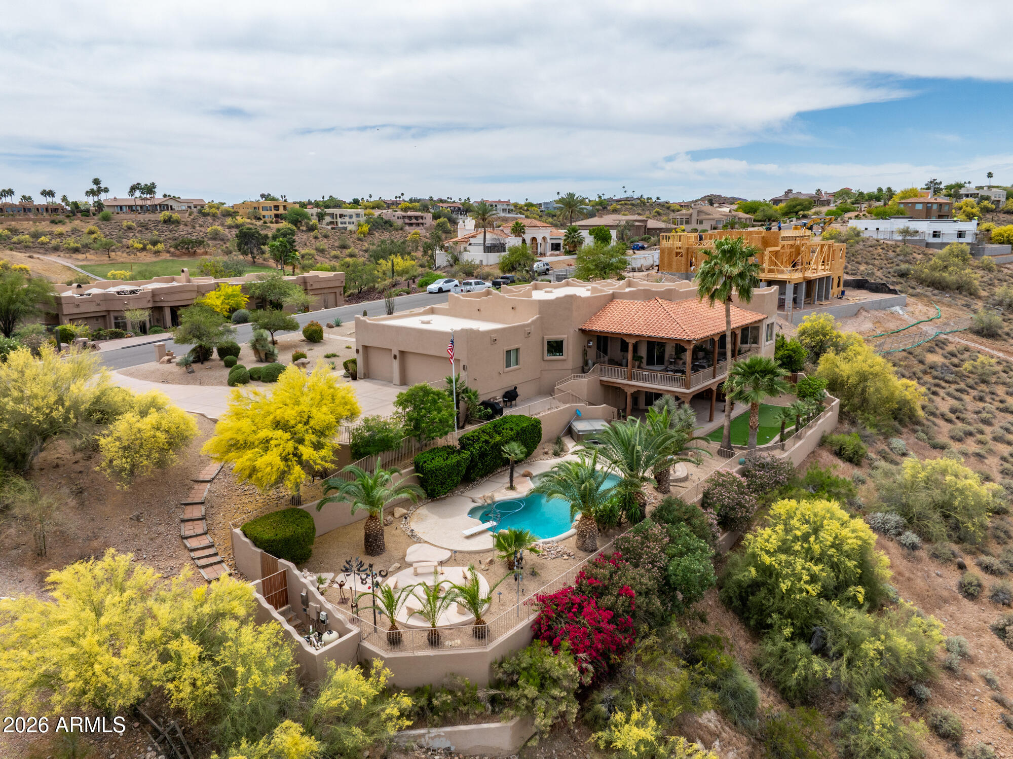 Elevated above the desert landscape, this custom-built residence with north/south exposure captures sweeping mountain vistas, lush Desert Canyon golf course greenery and endless Arizona skies from a truly premier vantage point. Perfectly positioned on a quiet spacious 1+ acre lot, the setting offers a rare sense of openness and tranquility while remaining moments from Fountain Hills conveniences, golf and outdoor recreation.  Expansive windows throughout the home frame picturesque views from nearly every room, creating a seamless connection to the surrounding vistas.  Warm, authentic architectural details - exposed wood beams, handcrafted Vega columns and rich natural finishes - add depth and distinction, while open living spaces are designed to capture light, views and effortless indoor/ outdoor  flow.  Designed for ease and livability, the main living areas  - including the kitchen, great room and primary suite - are all thoughtfully situated on a single level, each oriented to capture desert views and connect seamlessly to an expansive covered deck with sweeping mountain vistas.  The result is a calm, elevated everyday living experience perfect for alfresco dining, quiet morning coffee and breathtaking evening views.  The primary suite serves as a private retreat, featuring serene view windows and direct access to the covered deck, creating a seamless extension of the living space.  A guest bedroom with easy access to a full bathroom is located on the main level, with two additional guest bedrooms separated for privacy on the lower level, complemented by a spacious game room  - perfect when entertaining, relaxing or hosting extended stays.  Outdoor living is equally compelling, with a backyard that is a true retreat designed to take full advantage of the panoramic views - framed by mature palms and layered desert vegetation, with a sparkling diving pool multiple gathering spaces and the added convenience of an outdoor-accessed powder room.  This is a property defined by its connection to the surrounding beauty and its exceptional location at the heart of it all. All material information must be verified during the inspection period