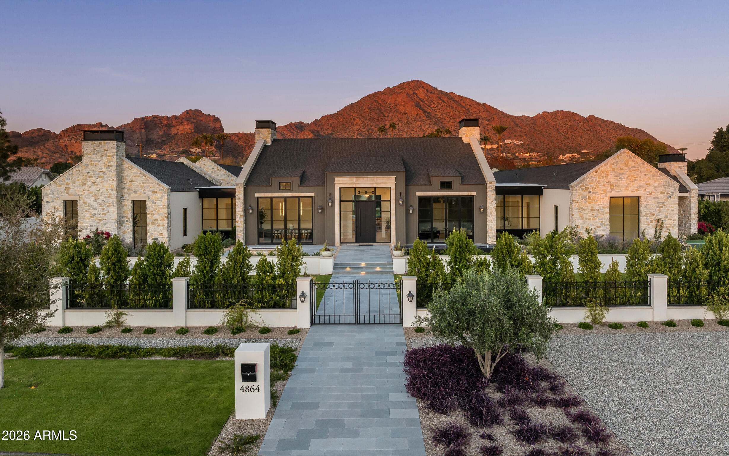 Brand new French Country-inspired estate by Two Hawks Design & Development in the heart of Arcadia. Sitting on .86 acres with 7,164 SF of living space, this timeless home blends classic European design with modern luxury. It features 5 bedrooms, 5.5 baths, 2 living areas, and 2 bonus rooms—plus a 4-car garage. Soaring ceilings and expansive windows frame Camelback Mountain views, while the resort-style backyard includes a pool, spa, lush landscaping, and pickleball court. Optional plans for a guest house or pool cabana available. A rare, fully finished masterpiece ready for its first owner.