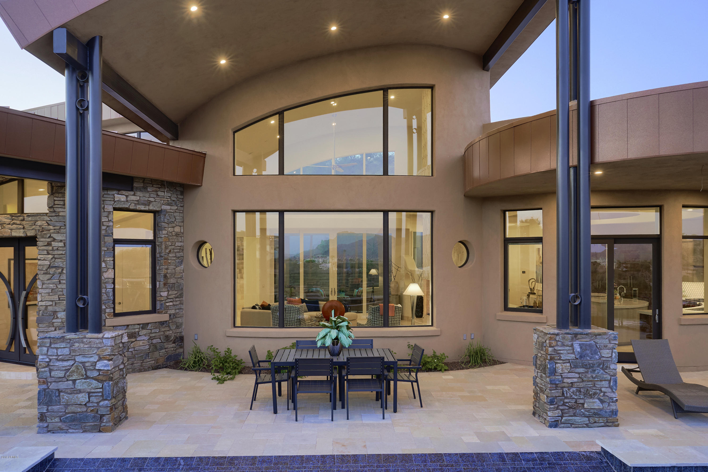 Situated to offer breathtaking views of Red Rock & Four Peaks, this brand new custom built home will inspire you w/ its very livable, casual elegance. While basking in the warm glow of the floor to ceiling Isokern Fireplace in the living room, the incredible views will also warm your heart! Adjacent to the formal dining room you'll appreciate the wine room w/ 2 sub-zero wine closets & wet bar which includes a built-in ice maker. The well appointed kitchen features wolf & sub-zero appliances including 2 dishwashers. You'll be delighted by the coffee bar & beverage center in the master bedroom which features another one of 4 Isokern fireplaces. A spacious walk-through shower awaits you in the master bathroom along w/ a large built-in tub w/ a picture perfect view & separate water closets. Another en-suite bedroom on the main floor features an under the stairs deep closet. Take those stairs up or ease into the elevator & discover the upstairs loft complete w/ an under counter fridge, microwave & sink in the kitchenette. You'll also find a spacious bonus room featuring another fireplace along w/ two en-suite bedrooms w/ custom shower tile & back splashes in the bathrooms. Each guest bedroom boasts a balcony offering exquisite views of their own. Custom designed solid core interior doors throughout add to the uniqueness of this home along w/ custom chandeliers & lighting. There's also a central vacuum system, pre-wired windows for electrical treatments w/ buil-in sunscreens, pre-wire sound system, Control4 smart home system & allowances so you can custom design your master closet & the upstairs floors. More custom designed doors highlight the 3 garages which include an air conditioned storage/work room along w/ Urethane epoxy floors. Just outside the kitchen door you'll find an outdoor grill & refrigerator highlighted by an infinity edge pool & hot tub facing those gorgeous views. And finally a separate detached casita w/ its own kitchenette & full bath creates the perfect guest/in-law accommodation.