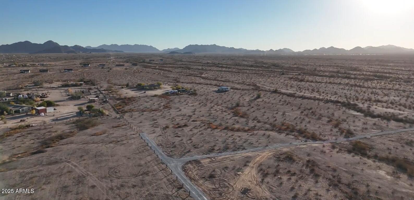 APPRX CENTER OF PARCEL HERE 33.242701, -112.468013   ENTER FROM ALAMO RD, NOT MANZANILLA.  BRAND NEW STEEL CASED WELL WITH PUMPING SYSTEM INSTALLED. ONLY 4 ON THE WELL.  ELECTRICITY NEAR THE NE PROPERTY CORNER. GRAVELED ROAD FROM ALAMO RD TO THE PROPERTY CORNER.  LEVEL LAND.  NO FLOOD ZONE. POPULAR LOCATION IN RANBOW VALLEY RANCH 2, IN UNINCORPORATED MARICOPA COUNTY WITH BUCKEYE ADDRESS.  SITE-BUILT AND MANUFACTURED HOMES OK HERE. OUTSTANDING MOUNTAIN VIEWS. AREA NEAR FUTURE 303 LOOP, I-11 AND THE SOUTHTERN PART OF ESTRELLA MOUNTAIN RANCH.  SELLER MAY CARRY. DON'T MISS THIS GREAT OPPORTUNITY BEFORE IT'S GONE.  PARCEL C OF THE SURVEY.