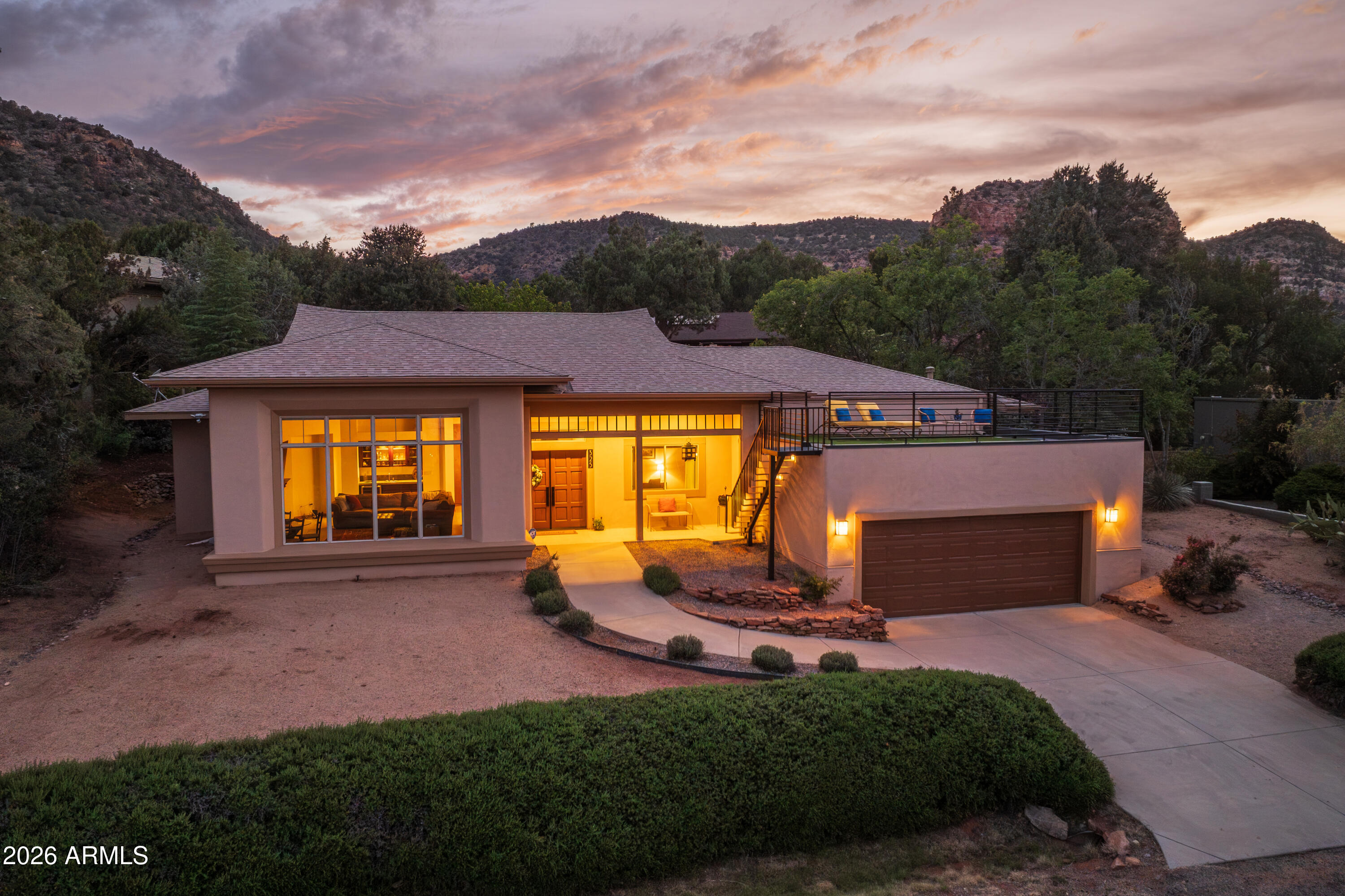 This is your chance to own a meticulously maintained, custom Prairie-style home -- 3 bed / 2 bath, 2,534 SQFT - where privacy and captivating red rock views coexist. Originally designed by architect John B. Scholz and built by Cavanaugh Construction, this home draws its design roots from the Frank Lloyd Wright era. Step onto the rooftop deck and take in Cathedral Rock, Thunder Mountain, and the Seven Warriors. Retreat to the tranquil backyard where a custom water feature fills the air with the sound of trickling water. 325 Montazona can be your next full-time oasis, or a guest favorite short-term rental (Buyer to verify with HOA). See documents tab for rental projections from pro forma. Inside, warm wood accents and notes of contemporary design welcome you. Buy with confidence... 325 Montazona's big-ticket maintenance items have been handled: newer composite roof (2021), new garage flat roof (2025), new furnace/coil (2025), new irrigation system, new water heater (2026), and more.

The foyer leads straight to the focal point -- a grand living room with vaulted wood beam ceilings, expansive red rock viewing windows, a gas fireplace, dual-zone wine cooler, and a wet bar. Flow into the primary suite and feel the shift to a zen atmosphere: DuChateau engineered hardwood floors, custom basswood Shoji doors opening to a private Arizona room, a jetted tub, walk-in shower, walk-in closet, and a private water closet.

The formal dining room adapts to your lifestyle - a serene sitting room, a game room, whatever fits. The kitchen delivers quartz counters, ashwood cabinetry, and updated stainless Bosch appliances. The neighboring breakfast room opens directly to the backyard patio and water feature - perfect for slow coffee mornings with the songbirds and evening entertainment.

Both guest bedrooms are bright, warm, and finished with the same DuChateau hardwood floors and solid-core doors. A dedicated laundry room houses a new GE Profile 2-in-1 vent-less washer/dryer. Head down to the garage and find two-car parking, ample storage, and easy access to the HVAC, water heater, and solar controller for the 7kW of fully owned solar panels.

The rooftop deck is the exclamation point - 360-degree red rock views and glowing sunsets that Arizona is known for. Recently updated stairs, railing, floors, and deck tiles complete the space.
325 Montazona is ready for you to move in, settle in, and soak in the Sedona lifestyle. 

*10 minute walk to Transept Trailhead
*5 minute drive to Clark's Market
*5 minute drive to Oak Creek Country Club

Select furniture available on a separate bill of sale.

***Recent upgrades.. see attached documents for a more detailed list***
- Dechateau engineered hardwood floors in all bedrooms
- New water heater (2026)
- New Furnace and coil (2025)
- New Garage roof (2025)
- New GE Profile appliances in kitchen and laundry
- Landscape irrigation
- Newer composite main roof (2021)
- Interior paint
- Living room picture window
- Window treatments in living room and bedroom
- Plumbing shut-off valves
- ADT bluetooth enabled security system
- Exterior security lighting and cameras
