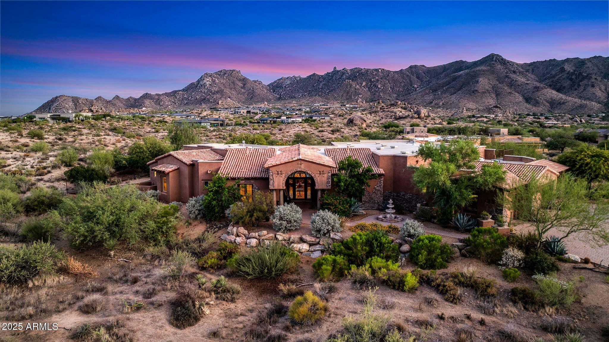 'Anyone can build a multimillion-dollar homebut a view like this can only be bought.' - Tom's Thumb, probably.

Perched high in the prestigious gated enclave of Rolling Hills within Sonoran Crest, this extraordinary 2+ acre estate defines timeless luxury and Scottsdale's most coveted lifestyle. Offering unmatched privacy and panoramic, jaw-dropping mountain vistas, the home frames unobstructed views of Tom Thumb and the McDowell Mountains from nearly every angle.

Designed for both grand-scale entertaining and intimate living, the expansive single-level floorplan features no interior steps and includes a private attached guest casita complete with its own full kitchen. At the heart of the home, a chef's dream kitchen boasts Subzero and Wolf appliances, a wet bar, a sunlit breakfast nook, and a welcoming family room anchored by a striking stone fireplaceall set against a backdrop of unparalleled natural beauty.

Entertainment extends beyond the kitchen with a dedicated home theater, surround sound throughout, and seamless indoor-outdoor flow. A rare oversized 6-car garagewith an extra-deep baycaters to car collectors and adventurers alike.

Outdoors, a resort-style paradise awaits: cascading waterfalls, a grotto-style pool, dramatic fire features, and a custom spa create an atmosphere of pure escape. A rooftop deck offers front-row seats to iconic Scottsdale sunsets, while the professional-grade Daco outdoor kitchen sets the stage for unforgettable gatherings.

This rare estate is more than a home it's a statement. A serene and elevated retreat with million-dollar views, yet just moments from world-class golf, dining, and outdoor pursuits.
