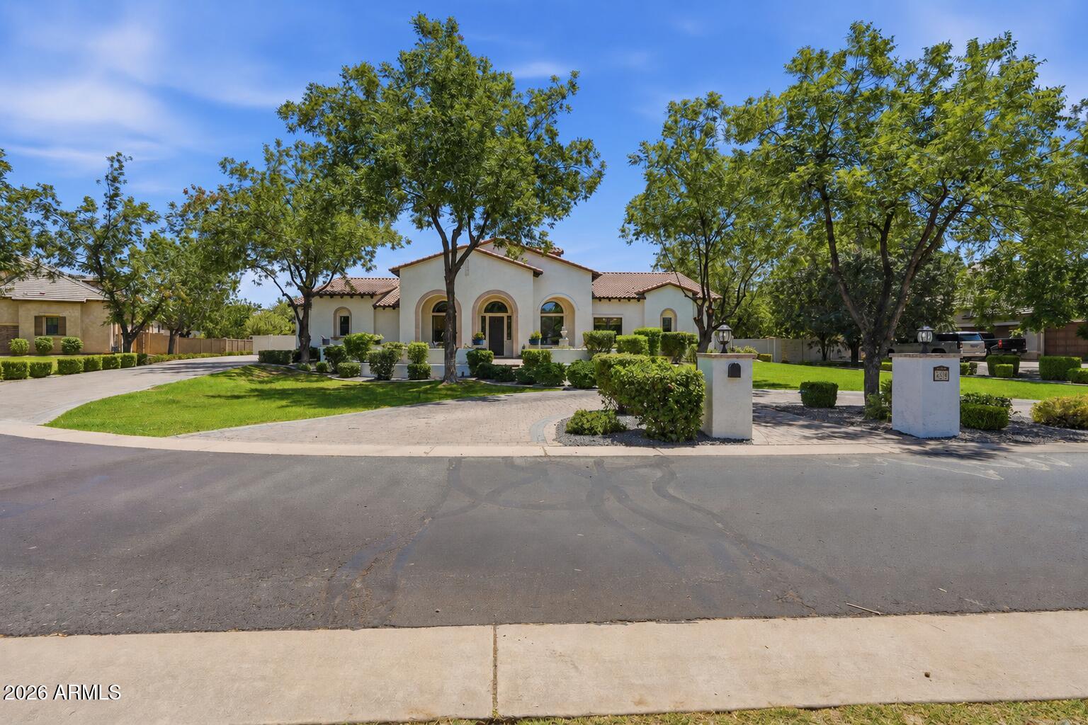 Nestled within the prestigious, privately gated, tree-lined enclave of The Pecans, this exceptional custom home offers timeless elegance, thoughtful design, and luxury at every turn. Perfectly positioned on a premium homesite with an ideal lot orientation, the backyard is perfectly suited for entertaining--welcoming crisp morning sunlight while offering relaxing shade throughout the afternoon and evening. Its convenient location within the community also provides quick and easy access in and out of the neighborhood.

An inviting courtyard and grand entry welcome you inside, where soaring ceilings and abundant natural light highlight the home's stunning finishes, luxurious textures, and exquisite architectural details. Designed with both everyday living and entertaining in mind, this impressive floor plan offers 5 bedrooms, 4 bathrooms, a spacious game room, a formal living room or private lounge, and an adjacent office. The formal living area and office also provide the flexibility to create two private home offices if desired.

At the heart of the home is a spectacular chef's kitchen designed to impress even the most discerning culinary enthusiast. Rich custom cabinetry is beautifully complemented by brand-new quartz countertops, an oversized island, premium appliances, and a 60-inch Monogram gas range. Every detail has been thoughtfully selected, including custom tile backsplash, double ovens, a beverage refrigerator, dramatic custom wood beams, and an impressive custom vent hood that serves as a stunning architectural centerpiece. Just beyond the kitchen is an incredible Butler's Pantry offering a second refrigerator, second sink, second dishwasher, extensive built-in cabinetry, and exceptional prep space. The kitchen opens effortlessly to the spacious dining area and inviting family room, creating the perfect setting for seamless indoor-outdoor living and entertaining.

The family room is warm, inviting, and beautifully appointed with vaulted ceilings, custom trim work, extensive crown molding, and an oversized pocket sliding glass door that completely opens to the backyard. Throughout the home, you'll find meticulous craftsmanship with custom millwork, extensive wainscoting, decorative beams, crown molding, designer lighting, and refined architectural finishes that create a seamless blend of sophistication and comfort.

The spacious primary suite is a true retreat, featuring French doors leading to the backyard and a luxurious spa-inspired bathroom complete with separate his-and-her vanities, a custom tile walk-in shower, a jetted soaking tub, and the added convenience of laundry hookups within the primary closet. A generously sized laundry room is equally impressive with abundant built-in cabinetry, a utility sink, and a custom drop zone with lockers for everyday organization. The oversized game room offers extensive built-in cabinetry, exceptional storage, and a pocket door, making it the perfect flex space for recreation, media, or family gatherings.

No detail has been overlooked throughout the home, from the grand foyer and expansive front patio to the circular driveway, RV gate, and oversized 4-car garage complete with custom built-in cabinetry. Step outside and embrace Arizona's signature indoor-outdoor lifestyle in a backyard that rivals a private resort. Designed for unforgettable entertaining and everyday enjoyment, the outdoor living space features an impressive pool with a custom waterfall, waterslide, and rope swing, along with a built-in firepit, built-in trampoline, and a fully lit pickleball and sports court. Whether hosting large gatherings or enjoying peaceful evenings at home, this backyard offers something for everyone.

Located in one of Queen Creek's most desirable luxury communities, this remarkable home is just minutes from Pecan Lake Entertainment District, shopping, dining, and top-rated schools. The Pecans is renowned for its beautifully designed custom homes by distinguished architects, offering residents exceptional privacy, tranquility, and security within one of the East Valley's most sought-after gated Communities.