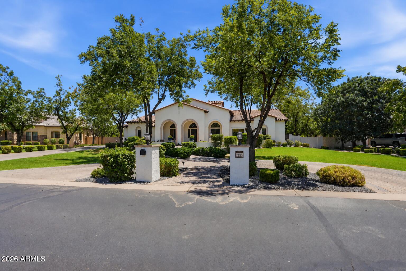 Nestled within the prestigious, privately gated, tree-lined enclave of The Pecans, this exceptional custom home offers timeless elegance, thoughtful design, and luxury at every turn. Perfectly positioned on a premium homesite with an ideal lot orientation, the backyard is perfectly suited for entertaining--welcoming crisp morning sunlight while offering relaxing shade throughout the afternoon and evening. Its convenient location within the community also provides quick and easy access in and out of the neighborhood.

An inviting courtyard and grand entry welcome you inside, where soaring ceilings and abundant natural light highlight the home's stunning finishes, luxurious textures, and exquisite architectural details. Designed with both everyday living and entertaining in mind, this impressive floor plan offers 5 bedrooms, 4 bathrooms, a spacious game room, a formal living room or private lounge, and an adjacent office. The formal living area and office also provide the flexibility to create two private home offices if desired.

At the heart of the home is a spectacular chef's kitchen designed to impress even the most discerning culinary enthusiast. Rich custom cabinetry is beautifully complemented by brand-new quartz countertops, an oversized island, premium appliances, and a 60-inch Monogram gas range. Every detail has been thoughtfully selected, including custom tile backsplash, double ovens, a beverage refrigerator, dramatic custom wood beams, and an impressive custom vent hood that serves as a stunning architectural centerpiece. Just beyond the kitchen is an incredible Butler's Pantry offering a second refrigerator, second sink, second dishwasher, extensive built-in cabinetry, and exceptional prep space. The kitchen opens effortlessly to the spacious dining area and inviting family room, creating the perfect setting for seamless indoor-outdoor living and entertaining.

The family room is warm, inviting, and beautifully appointed with vaulted ceilings, custom trim work, extensive crown molding, and an oversized pocket sliding glass door that completely opens to the backyard. Throughout the home, you'll find meticulous craftsmanship with custom millwork, extensive wainscoting, decorative beams, crown molding, designer lighting, and refined architectural finishes that create a seamless blend of sophistication and comfort.

The spacious primary suite is a true retreat, featuring French doors leading to the backyard and a luxurious spa-inspired bathroom complete with separate his-and-her vanities, a custom tile walk-in shower, a jetted soaking tub, and the added convenience of laundry hookups within the primary closet. A generously sized laundry room is equally impressive with abundant built-in cabinetry, a utility sink, and a custom drop zone with lockers for everyday organization. The oversized game room offers extensive built-in cabinetry, exceptional storage, and a pocket door, making it the perfect flex space for recreation, media, or family gatherings.

No detail has been overlooked throughout the home, from the grand foyer and expansive front patio to the circular driveway, RV gate, and oversized 4-car garage complete with custom built-in cabinetry. Step outside and embrace Arizona's signature indoor-outdoor lifestyle in a backyard that rivals a private resort. Designed for unforgettable entertaining and everyday enjoyment, the outdoor living space features an impressive pool with a custom waterfall, waterslide, and rope swing, along with a built-in firepit, built-in trampoline, and a fully lit pickleball and sports court. Whether hosting large gatherings or enjoying peaceful evenings at home, this backyard offers something for everyone.

Located in one of Queen Creek's most desirable luxury communities, this remarkable home is just minutes from Pecan Lake Entertainment District, shopping, dining, and top-rated schools. The Pecans is renowned for its beautifully designed custom homes by distinguished architects, offering residents exceptional privacy, tranquility, and security within one of the East Valley's most sought-after gated Communities.