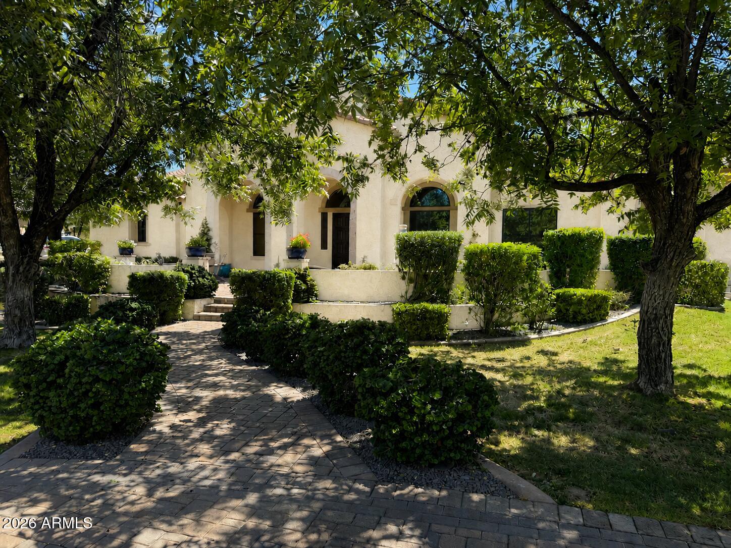 Nestled within the prestigious, privately gated, tree-lined enclave of The Pecans, this exceptional custom home offers timeless elegance, thoughtful design, and luxury at every turn. Perfectly positioned on a premium homesite with an ideal lot orientation, the backyard is perfectly suited for entertaining--welcoming crisp morning sunlight while offering relaxing shade throughout the afternoon and evening. Its convenient location within the community also provides quick and easy access in and out of the neighborhood.

An inviting courtyard and grand entry welcome you inside, where soaring ceilings and abundant natural light highlight the home's stunning finishes, luxurious textures, and exquisite architectural details. Designed with both everyday living and entertaining in mind, this impressive floor plan offers 5 bedrooms, 4 bathrooms, a spacious game room, a formal living room or private lounge, and an adjacent office. The formal living area and office also provide the flexibility to create two private home offices if desired.

At the heart of the home is a spectacular chef's kitchen designed to impress even the most discerning culinary enthusiast. Rich custom cabinetry is beautifully complemented by brand-new quartz countertops, an oversized island, premium appliances, and a 60-inch Monogram gas range. Every detail has been thoughtfully selected, including custom tile backsplash, double ovens, a beverage refrigerator, dramatic custom wood beams, and an impressive custom vent hood that serves as a stunning architectural centerpiece. Just beyond the kitchen is an incredible Butler's Pantry offering a second refrigerator, second sink, second dishwasher, extensive built-in cabinetry, and exceptional prep space. The kitchen opens effortlessly to the spacious dining area and inviting family room, creating the perfect setting for seamless indoor-outdoor living and entertaining.

The family room is warm, inviting, and beautifully appointed with vaulted ceilings, custom trim work, extensive crown molding, and an oversized pocket sliding glass door that completely opens to the backyard. Throughout the home, you'll find meticulous craftsmanship with custom millwork, extensive wainscoting, decorative beams, crown molding, designer lighting, and refined architectural finishes that create a seamless blend of sophistication and comfort.

The spacious primary suite is a true retreat, featuring French doors leading to the backyard and a luxurious spa-inspired bathroom complete with separate his-and-her vanities, a custom tile walk-in shower, a jetted soaking tub, and the added convenience of laundry hookups within the primary closet. A generously sized laundry room is equally impressive with abundant built-in cabinetry, a utility sink, and a custom drop zone with lockers for everyday organization. The oversized game room offers extensive built-in cabinetry, exceptional storage, and a pocket door, making it the perfect flex space for recreation, media, or family gatherings.

No detail has been overlooked throughout the home, from the grand foyer and expansive front patio to the circular driveway, RV gate, and oversized 4-car garage complete with custom built-in cabinetry. Step outside and embrace Arizona's signature indoor-outdoor lifestyle in a backyard that rivals a private resort. Designed for unforgettable entertaining and everyday enjoyment, the outdoor living space features an impressive pool with a custom waterfall, waterslide, and rope swing, along with a built-in firepit, built-in trampoline, and a fully lit pickleball and sports court. Whether hosting large gatherings or enjoying peaceful evenings at home, this backyard offers something for everyone.

Located in one of Queen Creek's most desirable luxury communities, this remarkable home is just minutes from Pecan Lake Entertainment District, shopping, dining, and top-rated schools. The Pecans is renowned for its beautifully designed custom homes by distinguished architects, offering residents exceptional privacy, tranquility, and security within one of the East Valley's most sought-after gated Communities.
