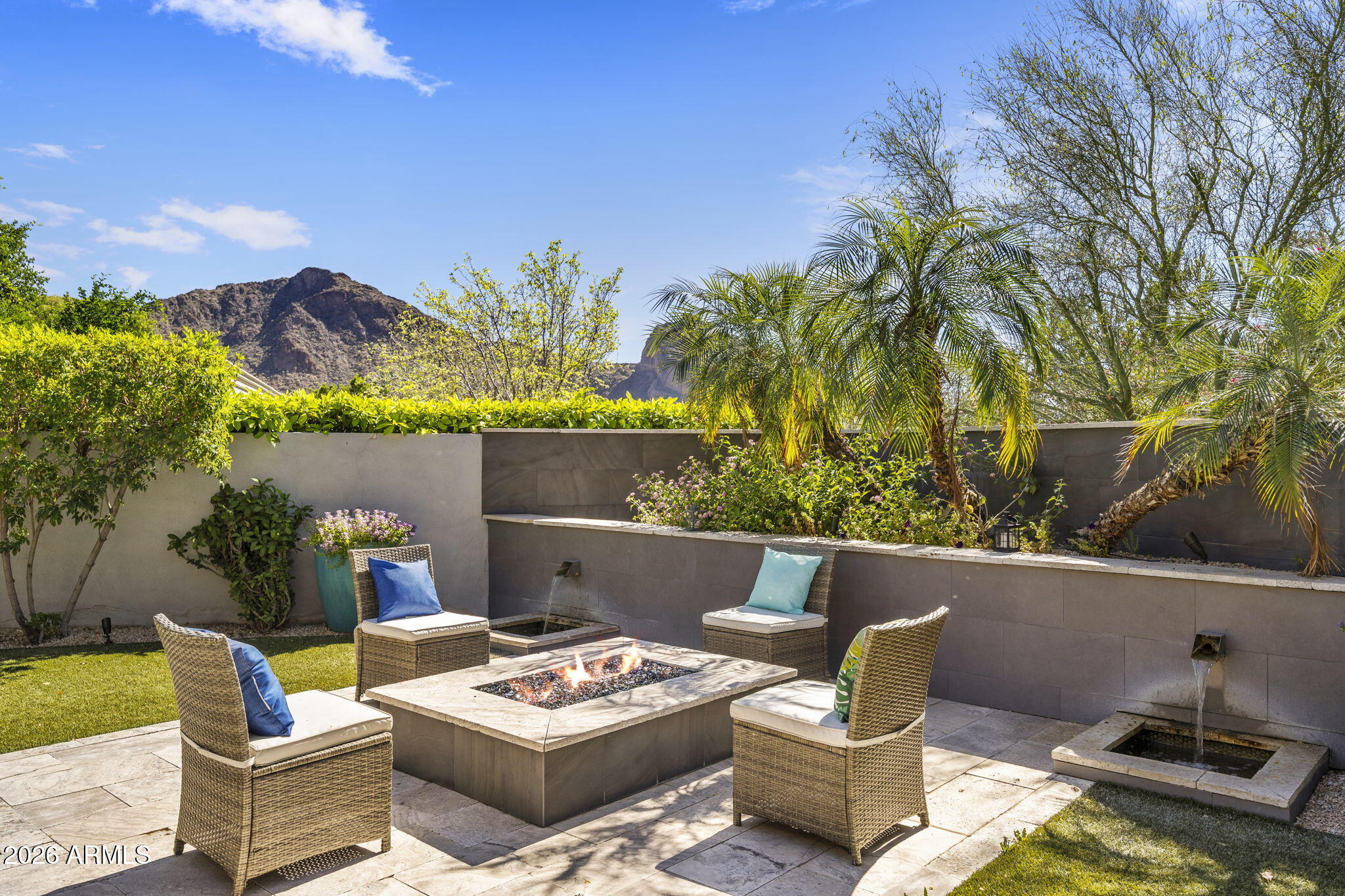 Paradise Valley's best kept secret is this residence nestled into the enclave of guard gated Colonia Miramonte! Built new in 2015, you will be impressed by the clean lines and fine finishes of this modern home situated on one of the best lots this private community has to offer, with Mountain View's in every direction. The perfect floor plan of 3 bedrooms en-suite, elegant powder room, office/flex rm is full of light and effortless living spaces. A massive 19.5' automated glass wall disappears into the frame, revealing a huge patio and stunning Camelback views. Fire pit, waterfall, serving bar area and Bertazzoni outdoor cooktop complete a fabulous entertainment element for fine dining or casual sunset moments. Kitchen command center is decked out with Wolf range, Sub-Zero fridge, butler service area with wine closet, PLUS huge walk-in pantry. Large primary suite has TWO walk in closets with marble bath and resort level peace. Guest parking spaces are close by along with a grassy park to enjoy any time of day. Minutes from the best restaurants and shopping areas in town! Enjoy total privacy in the heart of Paradise Valley!
