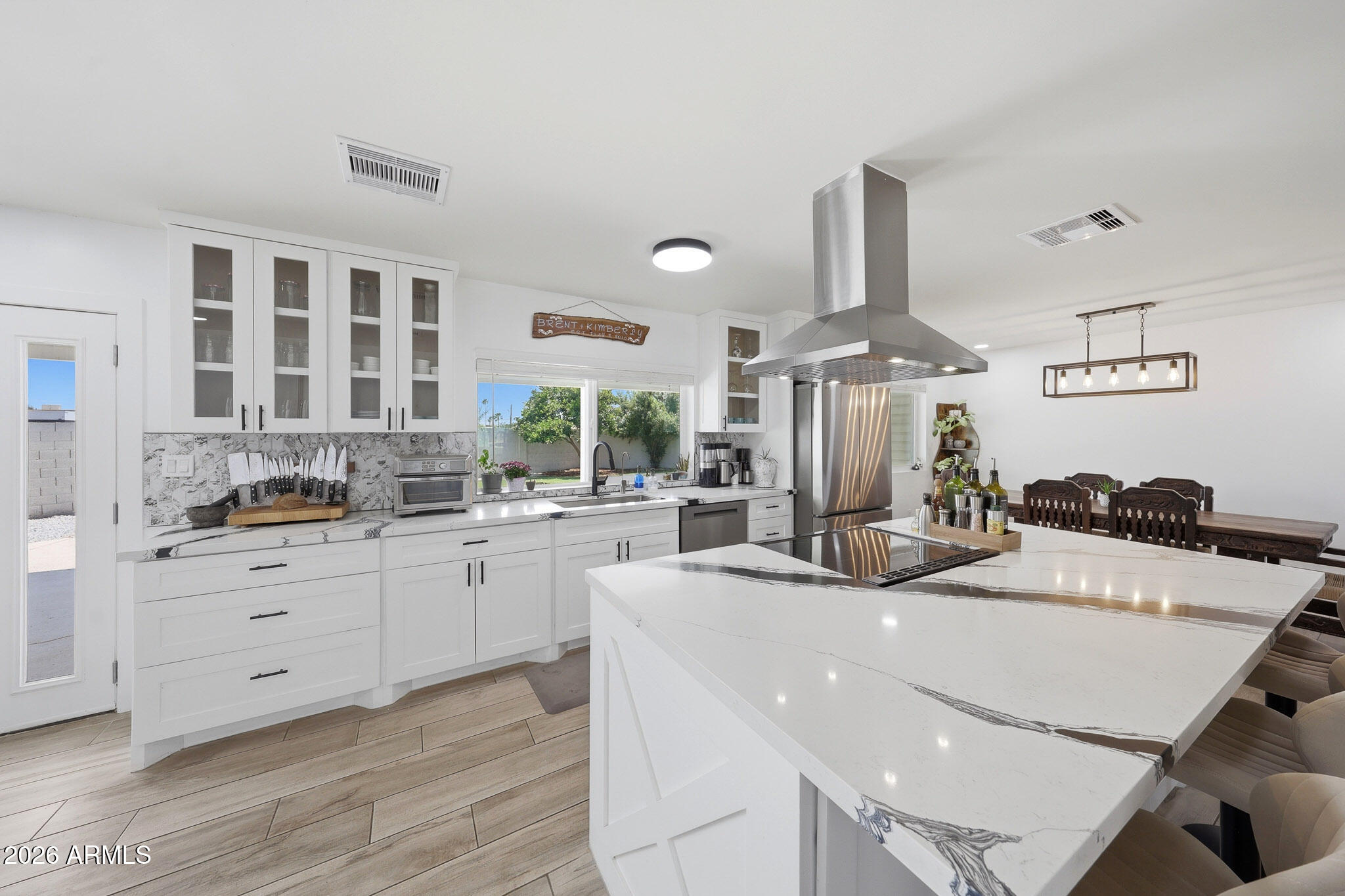 Completely renovated, this single-level 4-bedroom, 2-bath home sits on a premium 11,643sf cul-de-sac lot in the sought-after Bellair community. Offering over 2,000sf, the open great room floor plan is filled with natural light and features porcelain plank flooring, current finishes, and a wood-burning fireplace. The remodeled kitchen includes quartz countertops, marble backsplash, and newer stainless appliances. The spacious primary suite offers a walk-in closet with barn door and sleek en-suite bath, while three guest bedrooms share a beautiful secondary bath. Enjoy the deep covered patio and laundry room, oversized backyard ready for your dream oasis, 2-car garage, and RV gate. Walk to the Bellair Community Center and enjoy golf, pool, pickleball, clubhouse in a lush park setting.