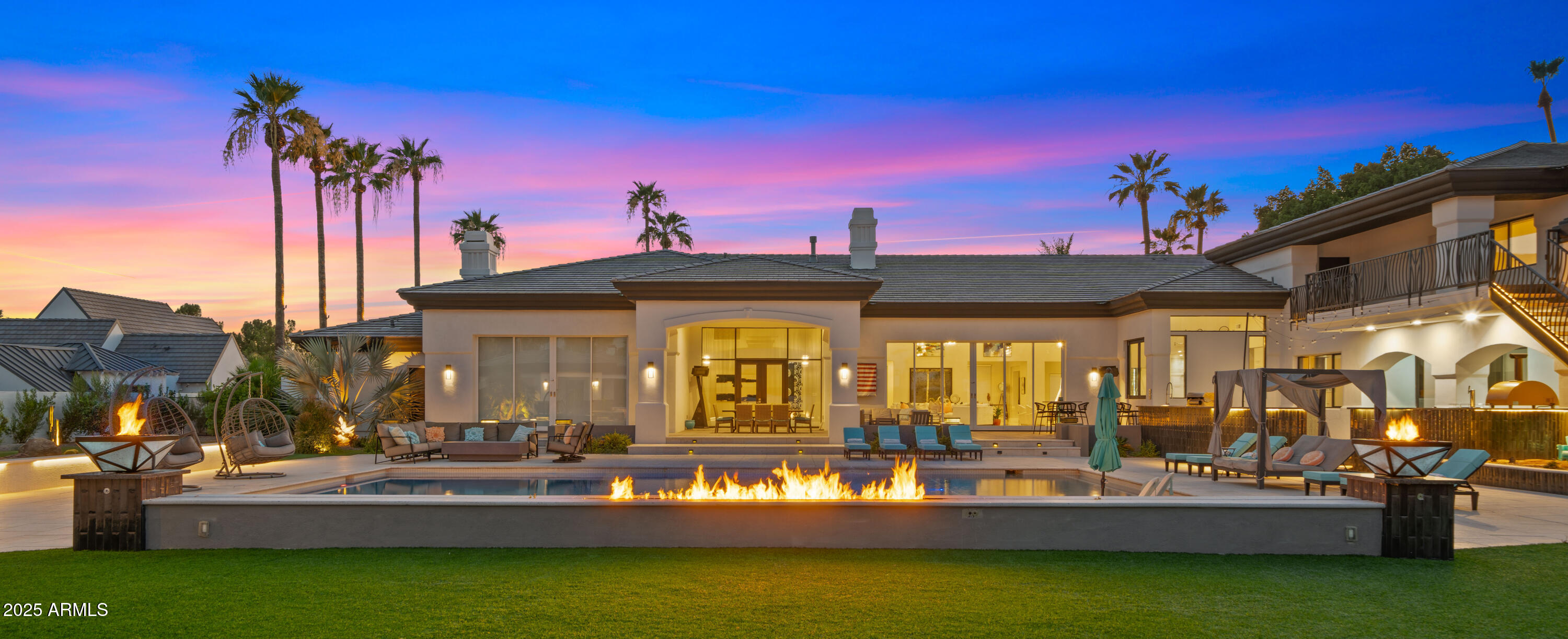 Welcome to the Arcadia Estate — a rare resort-style luxury residence in the heart of Arcadia proper, free from HOA restrictions. Nestled on one of the most prestigious streets, this nearly 10,000 SQFT residence captures iconic Camelback Mountain views while resting on an expansive lot of almost 1.5 acres—one of the largest and most private properties in Arcadia. The setting combines grandeur with seclusion, creating the feeling of a private resort in the city.

The grounds are nothing short of world-class, featuring a sparkling pool, full-size jacuzzi, infrared sauna, lighted tennis court, and private putting green—delivering the ultimate in recreation, relaxation, and entertainment.

Inside, the home showcases lavish interiors with timeless sophistication. The expansive great room boasts soaring ceilings and a seamless flow into the chef's gourmet kitchen, designed for both elegance and functionality. With a total of 8 luxurious bathrooms, including a spa-like steam shower, the home offers ample comfort and convenience for residents and guests alike. The main level features three en-suite bedrooms, each thoughtfully designed, while the upstairs wing includes a spacious family room, a private gym, two additional bedrooms, and a full bath with a separate entry, ideal for guests or extended family. This home is truly move-in ready, with furnishings available on a separate bill of sale, each piece custom-selected to complement and perfectly fit the residence.
The guest house is a luxury retreat of its own, offering a full kitchen, living area, two bedrooms, two bathrooms, laundry facilities, and private garageperfect for guests or extended stays.