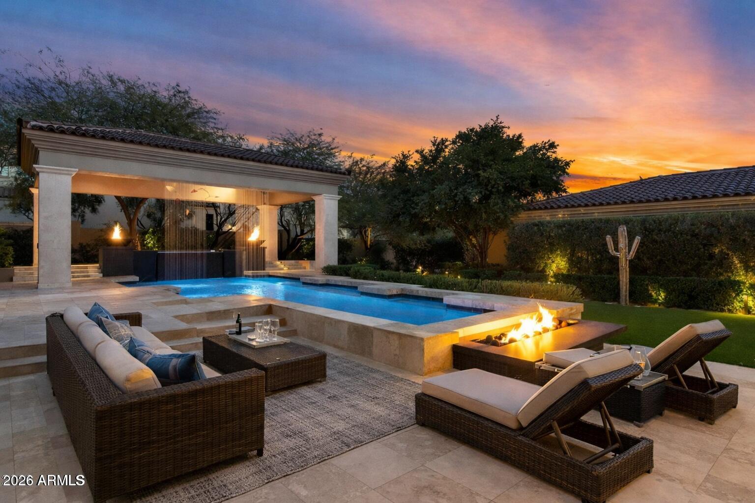 Welcome to the exclusive guard gated community of Silverleaf and experience one of Silverleaf's most masterfully reimagined modern estates located within the Horseshoe Canyon gate. A rare opportunity to live in one of North Scottsdale's most coveted addresses! Just moments from the world-class Silverleaf Country Club, this residence blends architectural sophistication, timeless design, and desert serenity into one extraordinary offering AND priced significantly below market value for discerning buyers seeking an exceptional opportunity.  From the moment you arrive, the home makes its breathtaking statement: soaring ceilings, custom iron-and-glass entry, and grand open spaces that invite both entertaining and intimate living. Wide-plank Oak wood flooring and artisan finishes create a sense of warmth and refinement, while a newly designed fireplace and curated lighting define a contemporary elegance that feels effortless and elevated.  
At the heart of the home, the chef's kitchen stands as a modern masterpiece anchored by an oversized island, premium Sub-Zero appliances, and bespoke cabinetry combining bold design with meticulous craftsmanship. The open-concept layout flows into multiple dining and gathering spaces that make both casual meals and evening soirees unforgettable.  
Take your own private elevator to the upstairs that leads to the serene & resort like Master Bedroom Suite. A private retreat where morning light dances across designer finishes and a private terrace captures panoramic views of Camelback Mountain and the shimmering city lights beyond. The suite's expanded layout includes a reimagined sitting are with a cozy fireplace, sophisticated décor, and a boutique-style dressing experience highlighted by Quartz counters and custom detailing.  
Three additional en-suite bedrooms ensure that family and guests enjoy the same level of luxury and privacy, while advanced home technology including integrated A/V, upgraded security, and high-speed connectivity enhances modern living at every touchpoint.  A four-car garage with new flooring and built-in storage underscores the home's thoughtful functionality.  
Outdoors, the property transforms into a resort-caliber sanctuary. Entertain beneath the stars with an outdoor kitchen equipped with a cooktop, grill, and large flat screen TV. Lounge beside the oversized heated pool and spa framed by elegant fire and water features, or relax around the fire pit and outdoor fireplace as music flows from the immersive sound system. With new artificial turf, updated landscaping, and meticulous lighting, every moment feels like a private retreat at a five-star resort.  
Ideally located near scenic trails, top-rated A++ schools, the boutiques and restaurants of Market Street at DC Ranch and just minutes from the 101 Freeway. This home offers rare access to Scottsdale's most desirable lifestyle. Modern design, timeless craftsmanship, and unmatched proximity come together in a residence that feels both aspirational and attainable...a true Silverleaf gem!