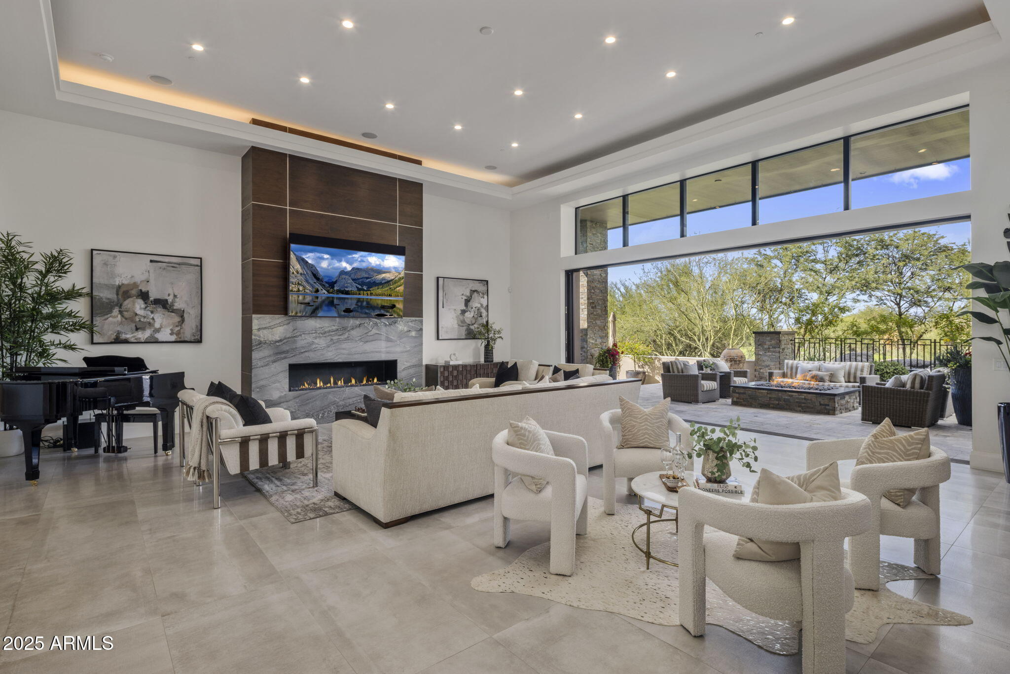This isn't just a home, it's your private vantage point to Troon North Golf Course and Pinnacle Peak, offering one of the best indoor-outdoor experiences in the entire valley. A  sleek, step-free contemporary home completed in 2020 inside the guard-gated Estancia community. Picture an open floor plan, a dramatic great room, and a disappearing wall of glass that makes your living room feel like part of the desert. Outside, you'll find two fire pits, an outdoor kitchen, and multiple patios overlooking the fairway and surrounding mountains. Inside, there's a chef's dream kitchen with a massive island, double-sided cabinetry, top-tier appliances, and a hidden butler's pantry with its own fridge. Every space here was designed to elevate how you live,