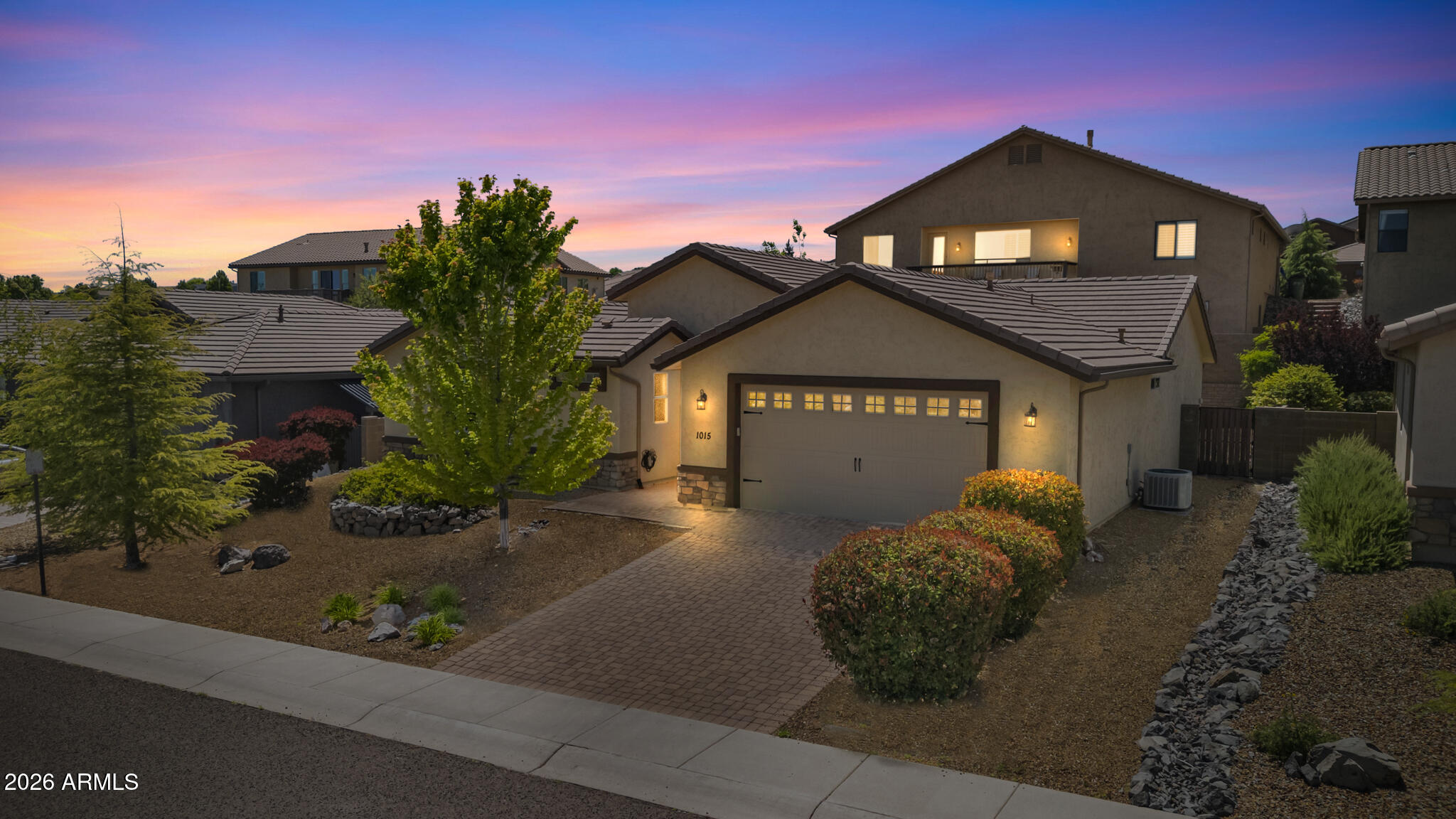Tucked within the charming gated community of The Reserve at Willow Hills, this move-in ready single-level home offers an ideal blend of comfort, style, and low-maintenance living. The stucco exterior with stone accents, tile roof, and paver driveway create inviting curb appeal, complemented by beautifully designed desert landscaping.
Inside, a thoughtfully designed layout opens to a bright and airy great room, anchored by a cozy gas fireplace with a mosaic tile surround. Wainscoting and built-in shelving add warmth and character, while tile flooring extends throughout the main living areas. The open floor plan creates a seamless flow, perfect for both everyday living and effortless entertaining. The kitchen is well-appointed with rich cabinetry, granite countertops, a decorative tile backsplash, and brand-new stainless steel appliances, including a range, microwave, refrigerator, and dishwasher. A large island with an undermount sink adds both function and gathering space. The adjacent dining area features vaulted ceilings, a Tiffany-style pendant light, and a bay window overlooking the backyard--an inviting setting for meals and hosting.
The primary suite offers a peaceful retreat with plush carpeting, a ceiling fan, and serene views. The en-suite bath includes a dual-sink vanity with granite counters, rich wood cabinetry, and a walk-in glass shower. Two additional bedrooms are generously sized with ample natural light and ceiling fans. 
A full guest bathroom features granite countertops, coordinating cabinetry, a tub/shower combination with classic tile surround, and updated fixtures. The dedicated laundry room adds convenience with upper cabinetry, a hanging rack, folding counter, and tile flooring. Fresh interior paint throughout enhances the home's turnkey appeal.
Step outside to a private backyard retreat, where a paver patio and retractable striped awning create a shaded space for relaxing or entertaining. Lush climbing vines along the block wall add both greenery and privacy.
With evening gated access providing added security and peace of mind, this home offers the ease of single-level living in a desirable community setting--ready for its next owner to enjoy.