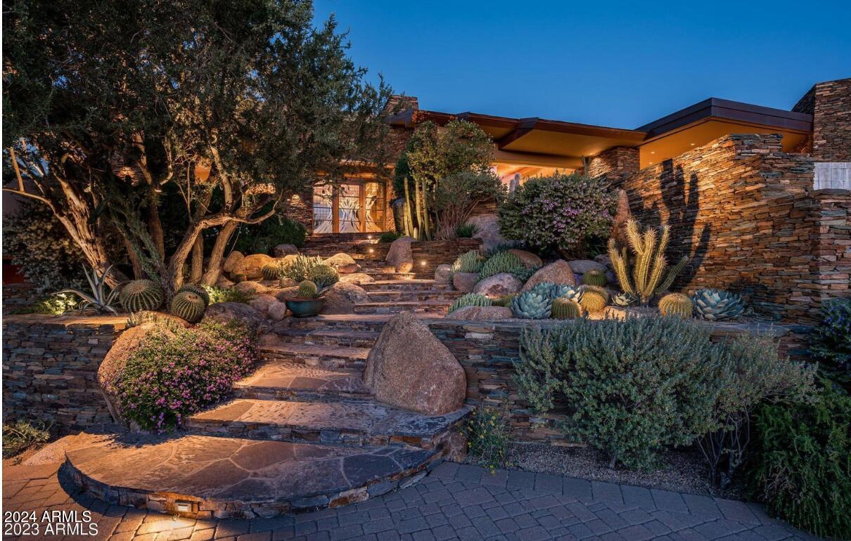 Desert Mountain Golf Membership available...Dramatic contemporary in prestigeous Seven Arrows Village designed by Craig Brown and built by renowned Manship Builders. Classic custom  finishes . Glass walls provide Sonoran Desert beauty and Apache Peak vistas to every room in the home. The dramatic gallery-style foyer features a succulent garden and flows to the great room, formal dining, spectacular library/den and luxury primary retreat. The great room opens to  covered  outdoor living & dining, a magnificent hearth, and a resort patio with forever  Valley views of sunsets and city lights. Chef's kitchen, sit-up bar and sunny breakfast room complete the main living level. The lower level is accessed by elevator AND from the main foyer by an elegant artisan-crafted limestone staircase with wrought iron rail, with it's own gallery walkway to the lower level amenities... wine tasting room with wine cellar, workout studio, two large ensuite Bedrooms with patios and pool access, powder room, laundry, flex room for home theater or simulator, and abundant storage. The home has an oversized garage with workshop area, separate storage and tandem 3-car parking.

For owners and guests who prefer no steps, the garage is at grade level, with a secondary grade-level formal entry foyer that's part of the lower level art-walk leading to lower level amenities and the grand staircase.

All in Fabulous Desert Mountain community with seven golf courses, 10 restaurants, HealthSpa/ Fitness center, pickleball, tennis, bocce and croquet courts, 20+ miles of private hiking trails, and a myriad of year-round planned activities. Club membership application/approval process is 30 days
