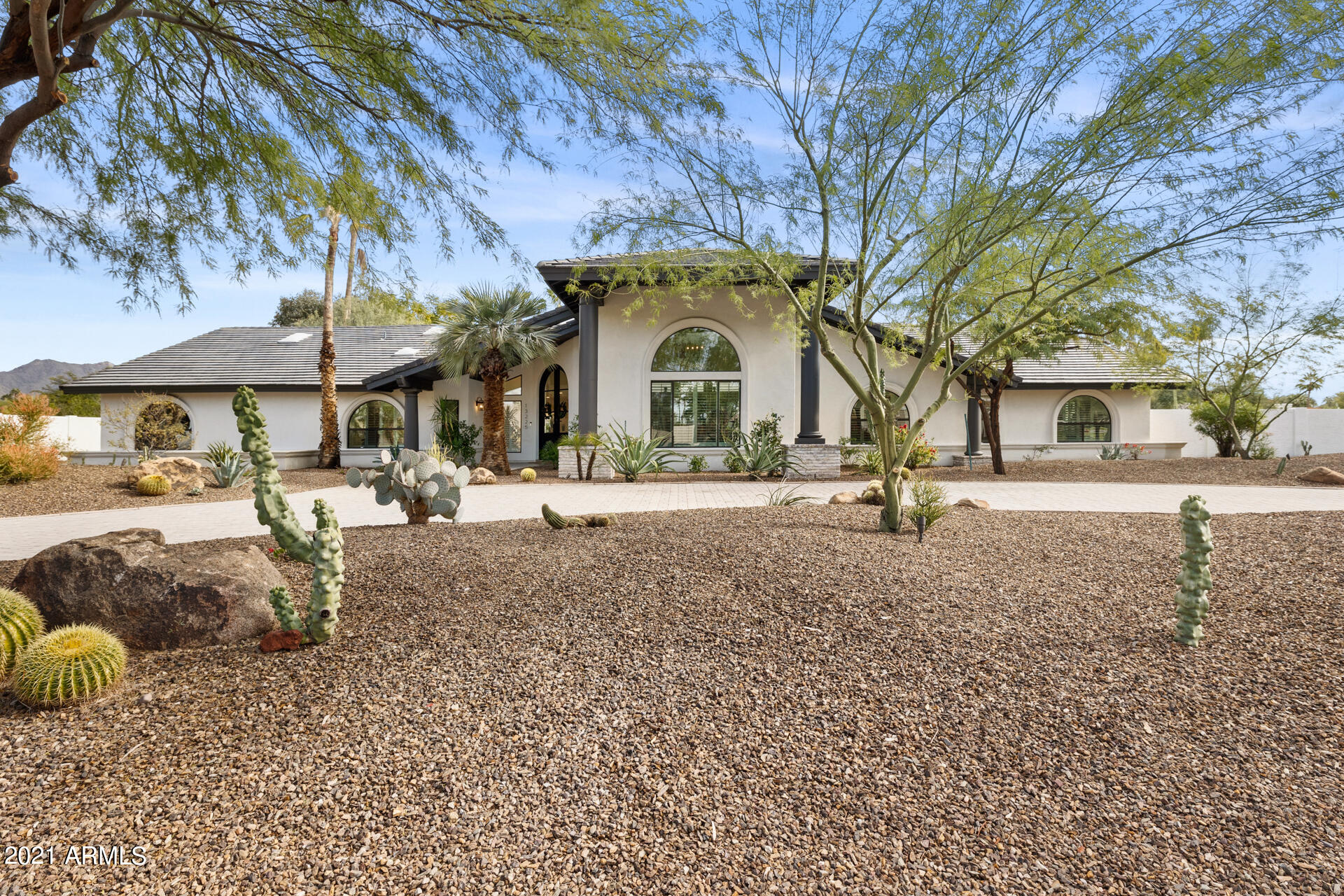 Welcome home to this gorgeous fully remodeled residence designed by SoHome Scottsdale. This beautiful home is situated on a .825 acre corner lot with no HOA in coveted Sunrise Estates featuring 4390 sf, 5 beds, 4.5 baths + office and incredible entertaining backyard and courtyard.Kitchen has large island and eat up bar open to family room with fireplace. Master suite boasts a den with double sided fireplace,  spacious spa-like bathroom complete with outdoor shower. Plenty of room to entertain in the private oasis resort backyard w mountain views, extended patio, large swimming pool & spa with new heater and smartphone app control system & ramada. Large side yard with room for RV garage or casita. Every surface of this home is updated! New paver driveway New Roof. Seller will consider trade