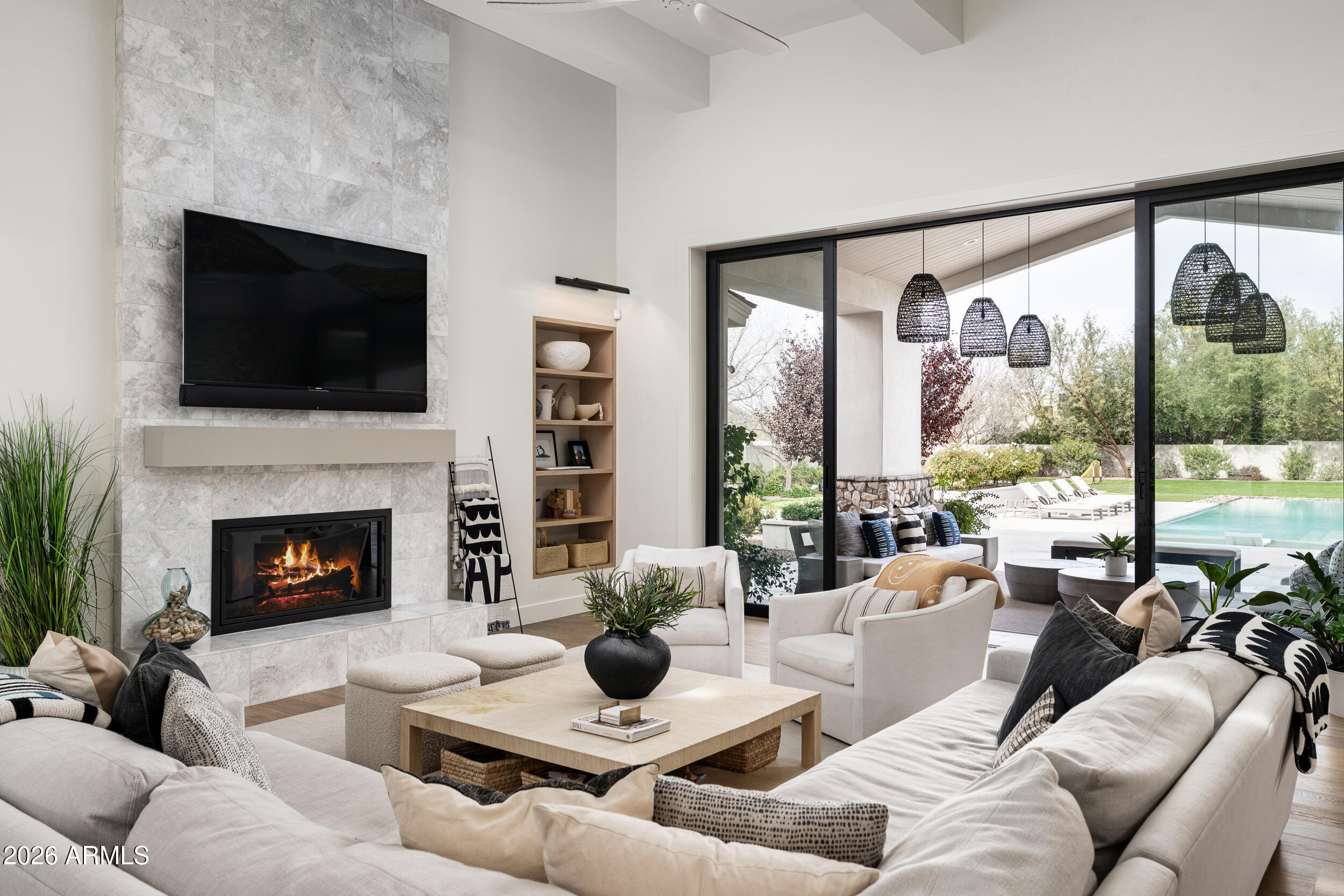 Located in the desirable Cholla Estates, this beautifully designed single-level residence offers approximately 4,500 square feet of thoughtfully curated living on a generous 1 acre homesite. Built in 2017 by Sonora West Development as the builder's personal home, the property reflects exceptional craftsmanship, quality, and attention to detail throughout. The open-concept great room flows seamlessly into a well-appointed kitchen featuring white cabinetry, a large center island, walk-in pantry, and high-end appliances--ideal for both everyday living and entertaining. Additional spaces include a formal dining room and private office, while four en-suite bedrooms provide comfort and privacy for family and guests. The spacious primary suite offers dual closets and the added convenience of an in-suite washer and dryer.
Outdoor living is equally inviting, with a front courtyard entry and fireplace, and a large covered rear patio overlooking a resort-style pool, built-in BBQ area, and expansive grassy yard with ample space for a sport or tennis court.
A rare opportunity to own a builder's personal residence in one of the area's most desirable settings.