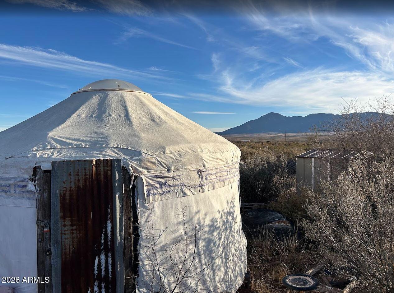 Welcome home to your own western paradise of nearly 10 acres with sweeping views in all directions. Utilities already installed (water for $300/year via well share, APS power, propane, septic, high speed internet) along with an affixed mobile home (newer roof and water heater) and outbuildings,currently a Yurt and platform for a second Yurt, you have the basis for a magical desert escape or base camp. Fenced property with additional yard fencing, plus a dog run or chicken coop, rock garage or walled vegetable garden, frame with partial green house windows, hitching post, private outdoor seating areas, walking paths with views and benches, and natural fencing on multiple sides. This property allows you opportunity to enjoy the clear evening skies and magic of the southwest. Rosemary, Pomegranate, and Prickly Pear grow, with walking paths lined with geodes, meteorites, copper, turquoise, desert rose stone, and antique items to create vignettes.  Just minutes to Douglas or Sierra Vista for full-time residence, or use it as a weekend retreat getaway. Once you walk the paths and see the views you'll understand why you want to make this home, with artists, geologists, persons seeking peace will love this property.