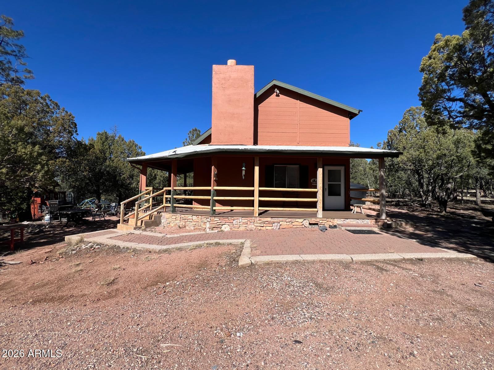 Nestled in the heart of Payson's natural beauty, this charming cabin-style residence offers a rare opportunity to enjoy space, privacy, and a true mountain lifestyle—just a short drive from Phoenix. Situated on approximately 1.17 acres in the desirable Ellison Creek Estates, the property is surrounded by mature trees, mountain views, and expansive green areas that define the serenity of Payson.

The home features 4 bedrooms and 2 full bathrooms across two interior levels, offering a warm and functional layout ideal for full-time living, vacation use, or short-term rental potential. Designed with families in mind, the cabin comfortably accommodates larger groups, with flexible sleeping arrangements that allow for up to 8 beds, thanks to built-in trundle-style sleeping solutions.