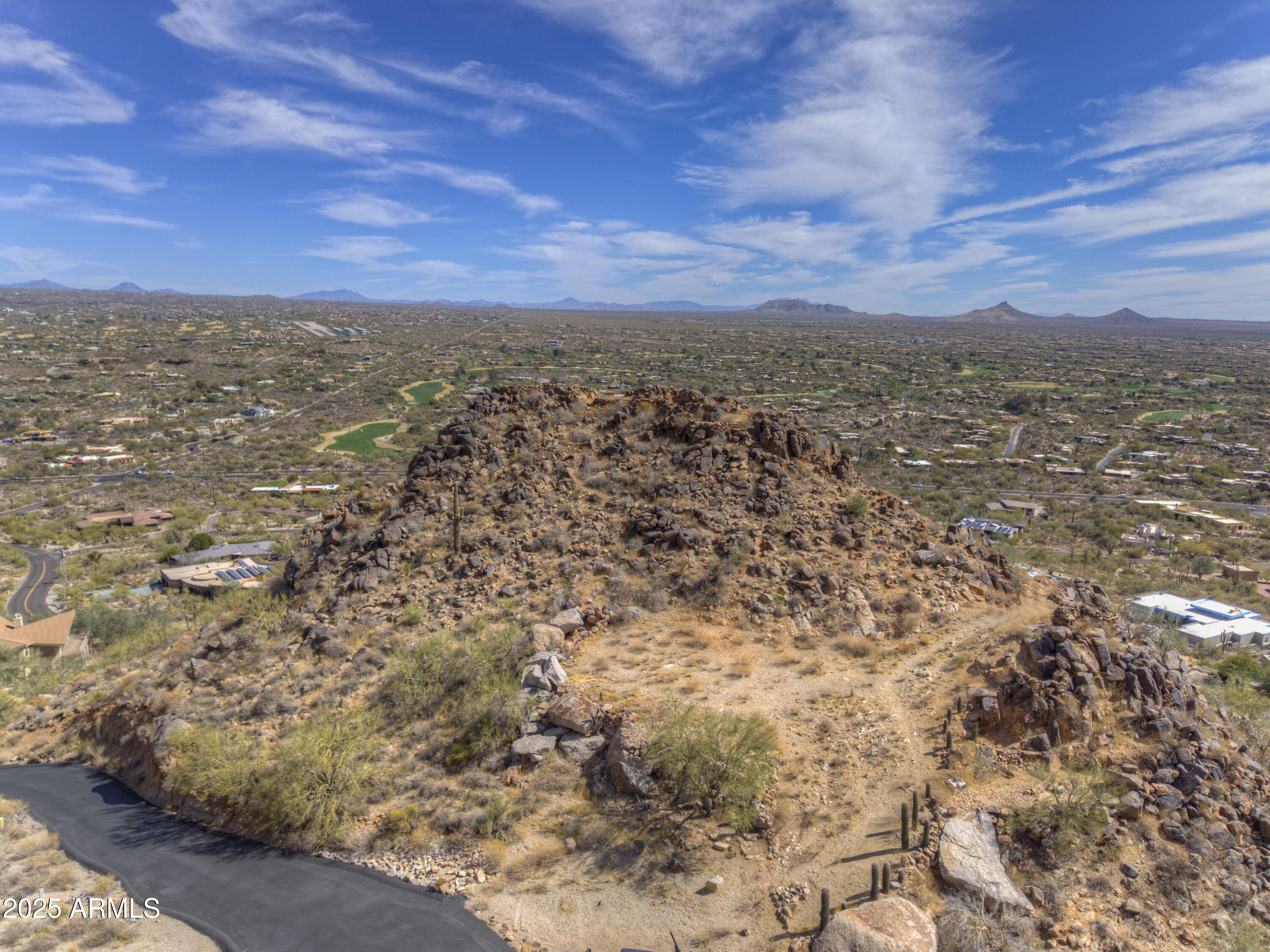 An exceptional 4.72-acre double lot, free from HOA restrictions, presents a rare opportunity to create your dream home high on the sought-after East slope of Black Mountain renowned for its breathtaking boulder formations and architecturally distinctive homes. A newly paved driveway provides access to just 4 estate-sized lots adjacent to Preserve, ensuring privacy and exclusivity. Seamless access to the cul-de-sac w/ available Water, Sewer, Electric & Gas. The prime building site offers unparalleled panoramic views: North to Continental MTN; over The Boulders Resort extending to Scottsdale / Carefree and south to Camelback Mtn w/ Twinkling City Lights of Phoenix. A true landmark featuring a striking Black Rock outcropping, where the previous owner envisioned a future outlook at the Peak!