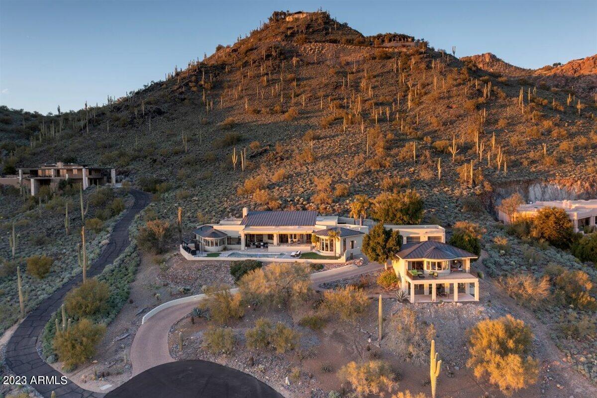 Stunning fully renovated home on south side of Black Mountain! *see docs tab for full list of features* 
Breathtaking views from every room in this home including the guest house! This property is perfect for entertaining, families or a 2nd home getaway. An impressive water feature with living wall greets you as you enter the courtyard. Through the custom glass and iron pivot front door you step into the lounge featuring a nearly 1,000 bottle wine room. Beautiful tile in all the right areas and custom cabinets throughout. Main house offers 3 bedrooms, office and a media room with 4 full baths.  1,920 sq ft of total square footage is the guest house, which is fully equipped with a complete kitchen, laundry, one bed, one bath and great room setup. The views on the deck are breathtaking! The bottom level of the guest house has endless possibilities! It could be a gym, music studio, art room, office... whatever you desire. Information available to make it additional casita setup if needed. 
Both main and guest house have custom lighting, high end finishes, smooth/no texture walls and did I mention the views! 
This is a must see!