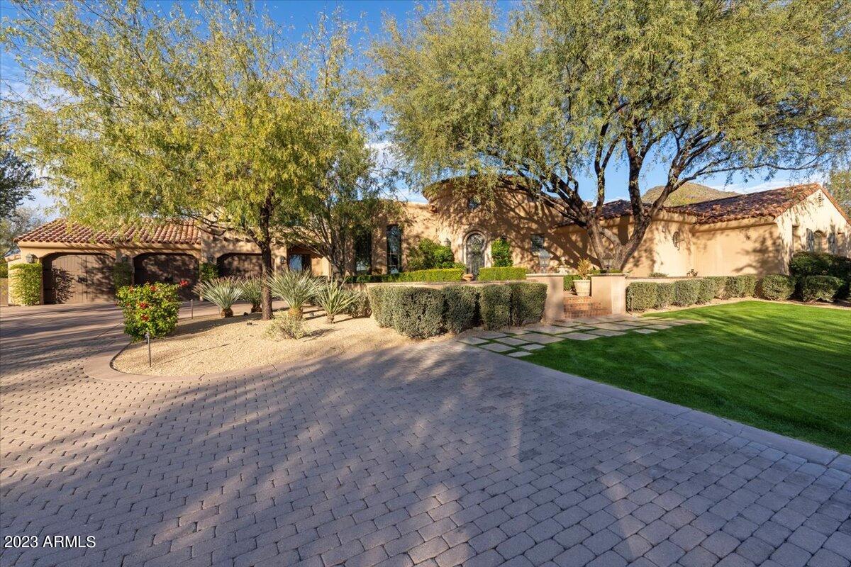 This beautiful Mediterranean-inspired estate with extraordinary curb appeal is nestled on a 1.2-acre homesite amidst a backdrop of McDowell Mountain views. Located within the guard gated community of DC Ranch Country Club, this residence offers lush landscaping and charming outdoor spaces including a front courtyard with fountain, expansive yard with mature trees and artificial turf, sparkling pool with stone water feature wall, spa, fireplace with bench seating, backyard Ramada with fireplace and TV, additional BBQ area, and spacious covered patios. Inside, you will find an open and functional floorplan with lots of natural light and abundant use of French doors. The hub of the home is the open kitchen, family room and eating nook with windows framing the backyard views. The spacious master suite is split from the guest bedroom wing, which consists of 3 bedrooms surrounding a bonus room. On the second level you will find a bonus/game room with built-in cabinetry, wet bar, and a balcony to enjoy the mountain views. This residence is just a few minutes' walk through a quaint pocket park to the Country Club at DC Ranch clubhouse.  Hop on the surrounding community pathways that stretch for miles and follow them to Market Street, Desert Camp Community Center, or simply enjoy a scenic walk through the neighborhood.