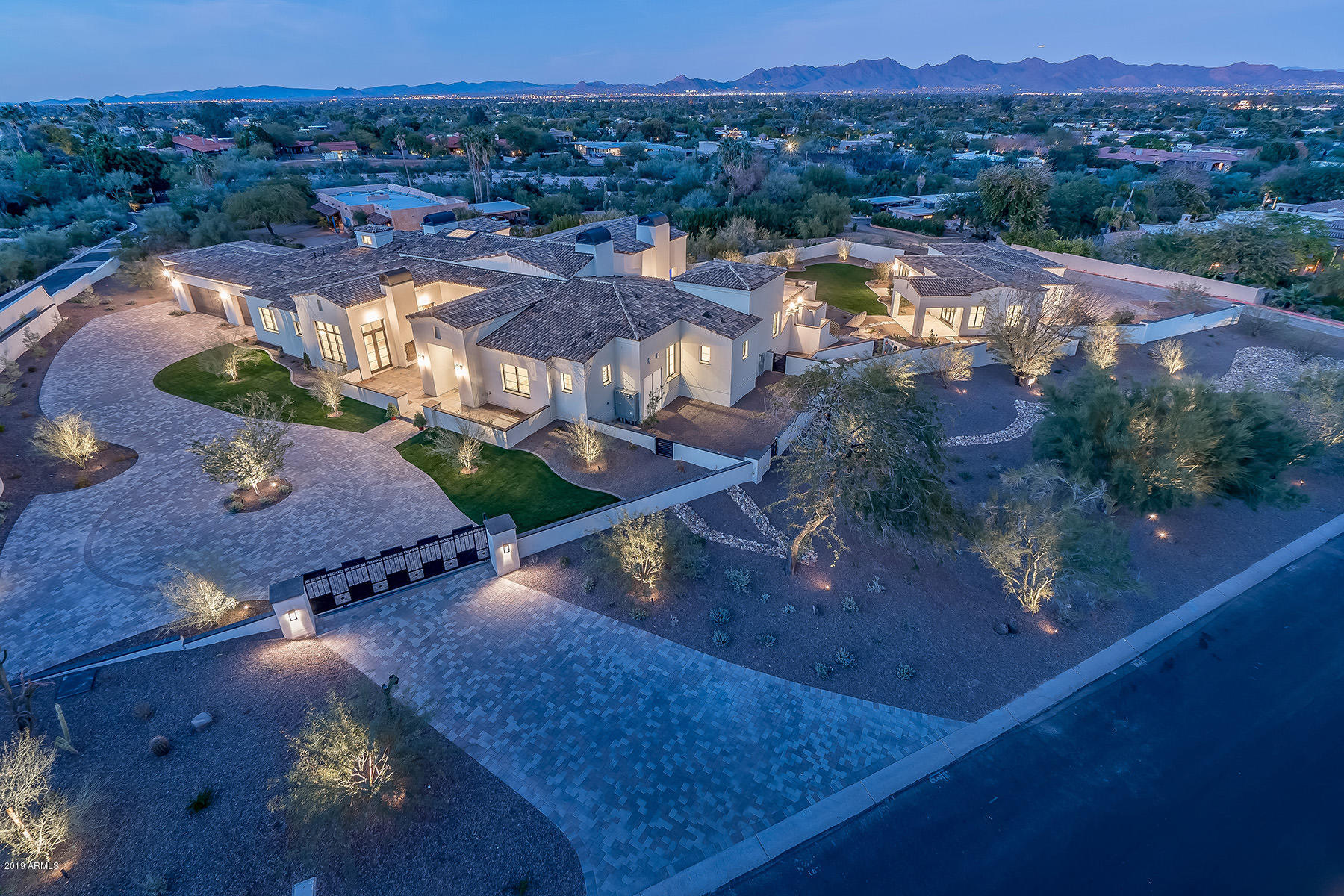 Impeccable 2018 Santa Barbara transitional design by Mark Candelaria. The utmost quality of detail and extraordinary taste are unparalleled in this luxury residence. Beautifully nestled on 1.7 acres in the foothills of Mummy Mt, this privately gated home boasts 7,425 total s/f, magnificent views of the McDowell Mts., French Oak flooring, imported stone fireplaces, Calcutta Gold counters, office, theatre, 4 car garage and Control Four smart system. The chef's kitchen features Wolf, Sub Zero, Asko and Miele appliances with a walk-in cooler. An expansive patio, negative edge pool/spa, fireplace and 2 fire features overlooking spectacular mountain views are perfect for entertaining. The 2 bedroom/2 bath  1,425 guest house includes a full kitchen, family room and 3 car garage.