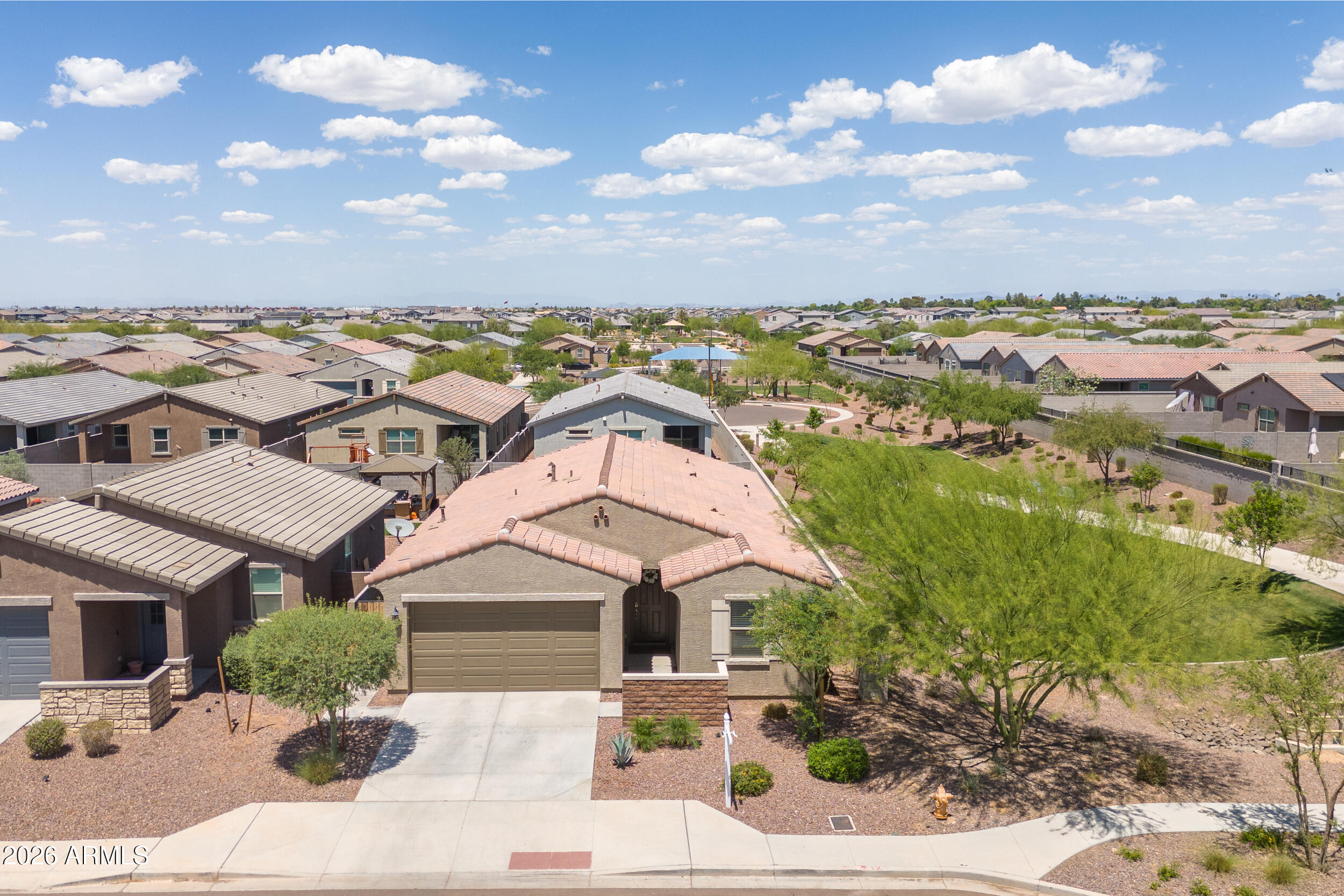Better than new and move-in ready in a desirable gated community! This beautifully maintained home offers all the benefits of new construction without the added cost or hassle. Thoughtfully upgraded throughout with window blinds, ceiling fans, epoxy garage flooring & a finished backyard already in place.

The open-concept layout is perfect for everyday living & entertaining, featuring a spacious great room that flows seamlessly into the kitchen with a large island, espresso cabinetry, granite countertops & stylish tile flooring.

Situated on a premium lot next to the greenbelt, this home offers added privacy with only one neighboring property. Conveniently located near Loop 202 and I-10, making commuting & daily living a breeze.

Skip the wait and extra costs - this beauty has it all
