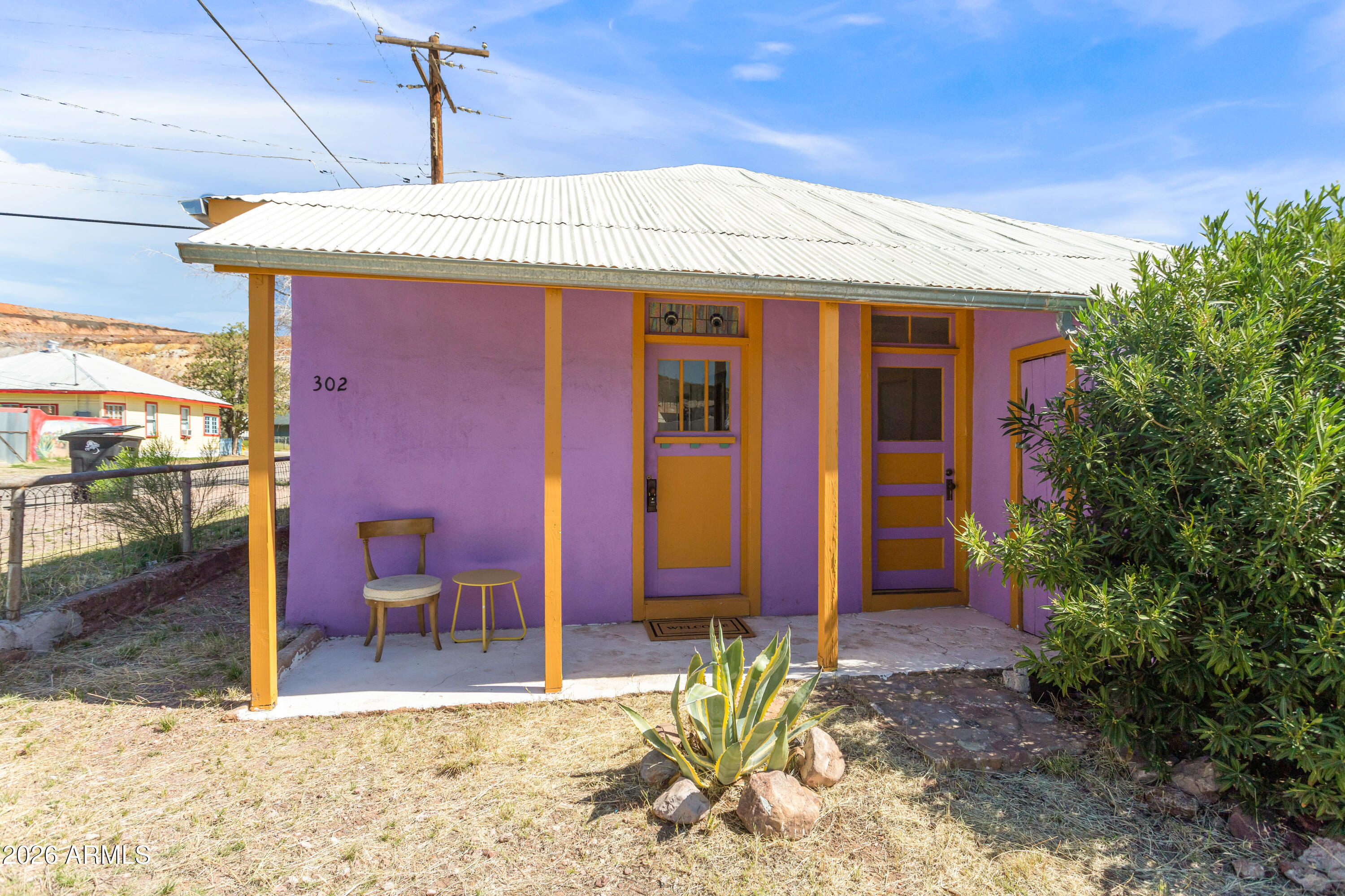 Solid little house that was brought back to life in 2022/23! One bedroom, one bath, approximately 675 sq ft house. All electric everything, dual pane windows, clawfoot tub, ductless heating and cooling (mini split), new electric meter (2022), stained glass transoms, saltillo tile and hardwood floors. It has an exterior storage area and covered porch on one side. Located by the Hitching Post and the shops in Bakerville. The front yard has some established cactuses and a beautiful old juniper tree. The home sits on relatively level ground with easy access. It's the kind of small Bisbee house that feels welcoming and full of good vibes. Make it your own!