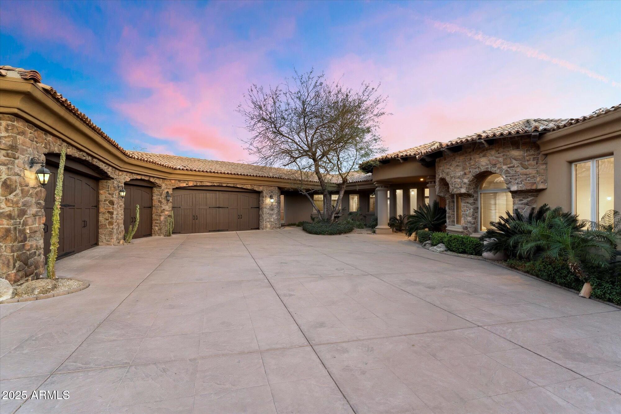 New Roof installed in April 2026, within the guard-gated golf community of Ancala Country Club, stands this grand-scale residence. Offering a split floor plan on an exceptional elevated corner lot capturing unobstructed sweeping city lights and Mountain Views. The primary suite is set on the main level; as a peaceful retreat, it offers breathtaking views, a spa-inspired bath with steam shower, dry sauna, and dual water closets. Expansive interiors include a theater, office, fitness/bonus/game room, along with generous guest suites. The lower-level walkout opens to an entertaining-style backyard featuring a pool with a waterslide, spa, fire pits, outdoor fireplace, built-in BBQ, and misters on the upper balcony provide comfort while taking in panoramic views. A gated motor court and temperature-controlled 5-car garage complete this extraordinary home. Ancala Country Club offers a family-friendly atmosphere, a challenging Perry Dye golf course, and a range of social, sports, and golf memberships. A rare and truly remarkable offering.