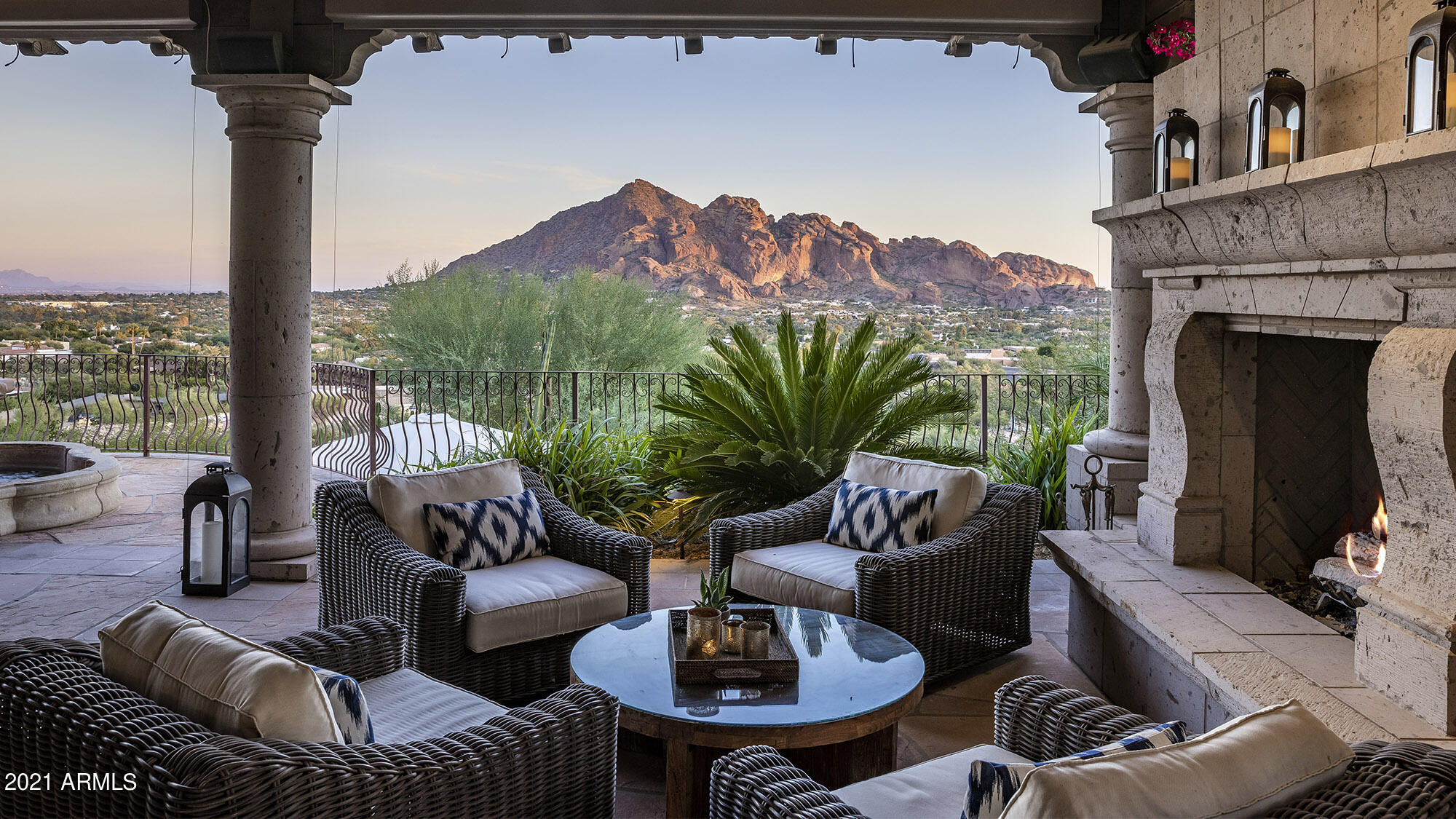 A serene hillside setting in Paradise Valley sets the stage for the incredible views of Camelback Mountain, Mummy Mountain, Superstition, South Mountain, Phoenix Mountain Preserve and Phoenix city lights from a coveted south and southeastern views.  There is a new light show across the mountain every evening and welcoming sunrise to the east to greet you every morning. 
This home's interior was completely renovated by award winning luxury home builder, Cullum Homes, in 2016.  The architecture includes beautiful tongue and groove, vaulted beamed ceilings with expansive windows that wrap around the house, clerestory windows to add interest, spacious covered patios, charming waterfalls, fountains, and fireplaces abound and a sophisticated, but comfortable interior décor complete this... ...peaceful mountain retreat. 

It's exterior space and landscape, designed by Greg Trutza of New Directions in Landscape, graced the pages of Phoenix Home & Garden's magazine in 2003.  The space is truly an outdoor extension of the living room and large enough to entertain, yet intimate enough for just two. The work was so extensive, that Trutza worked with Higgins Architects and G.M. Hunt Builders, who had completed a recent home addition, to complete the project.
A charming flagstone garden path, with tranquil rock waterfall and firepit, leads you to a beautiful outdoor foyer with a billowed, fabric, retractable roof.   The front hillside and plant vegetation create a shady alcove that provides cool summer opti for quail and dove alike.   The wall-to-wall glass entrance gives you a sneak peak of the expansive space and views that await you and when left open creates a Zen feeling while entertaining or just enjoying the quiet this location has to offer. 
You enter a home of beautiful, calm tones, soaring ceilings, expansive windows that allow nature and all the surrounding mountains to join you!  Wide plank, French oak flooring flows thought the home to create a seamless and consistent feel. As you are drawn to the living room, with its Mexican hand-cut limestone fireplace, you pass the dining room that overlooks the living room and accented with a simple, sophisticated iron railing.  Expansive windows and French doors present a stunning view of Camelback Mountain and city lights.  The living room offers a wonderful gathering area and opens out to two patios, one expansive will a commanding fireplace and entertainment space and the other a quaint setting to watch the morning sunrise, coffee in hand.   
The kitchen highlights much of the updating from the complete interior remodel by Cullum Homes in 2016.  Subzero, Wolf and Asko appliances, Quartzite counters and white, painted cabinet, subway tile, polished nickel plumbing fixtures, and kitchen island. An additional French door was added to access the large, incredible covered patio space.
The 1,200 square feet of flagstone and reclaimed paver covered patio draws you out of the house almost immediately. It's vaulted, tongue and groove, beamed ceiling and terracotta pillars compliment the slump block construction and massive Cantera fireplace.  An imported Italian marble water fountain, positioned on a beautiful half-circle patio overlooking the lower backyard, adds the water element and misters help extend the use of this incredible outdoor space.  The upper patio wraps around to an outdoor kitchen, with built-in grill, sink, bar and counter. Access to the front garden allows for easy in and out for catering services. The patio gains privacy from bougainvillea, oleanders, massive heritage desert plants and Palo Verde, while still inviting beautiful hummingbirds!
A curved, iron railed stairs take you to another tranquil space with a hand-cut stone grotto, oversized, heated, spa with firepit and turf area for lounge chairs and sun-bathing.  The large patio connects along a path to the smaller patio, outside the family room that looks to the east and offers an additional 154 sq. ft. of covered patio. The eastern patio connect all the way to driveway, again, making for easy access or catering services. 
The family room, adjacent to the living room through French doors, to separate the rooms for media or office use, is also accessible via a windowed alcove and shares the 16-foot vaulted ceilings and wide, tall windows that the living room boasts.  It feels expansive and cozy at the same time! An office desk, bookcases, wine refrigerator and a dry bar, surround the perfect TV view area and gas fireplace with custom limestone mantel.  The panoramic views encompass the room and French doors irresistibly lead you outside to a quaint patio and sitting area with brick fireplace, that wraps around to the large patio to the west. 
The owner's suite, with corner, woodburning, beehive fireplace and updated raised limestone hearth, creates another Zen retreat in the home. Owners wake to picture frame views of Camelback Mountain through yet another French door!  Beautiful white linen drapes and white wooden shutters help on days set aside for sleeping in.  The remodeled marble bathroom has a double sink and wide counter with plenty of storage, make up vanity and soaking tub that overlooks the front secret garden. A large walk-in shower provides rain shower and flexible shower heads, corner seat and storage niche. To finish it off, there are two walk-in closets with custom built-ins.
Two guest bedrooms, both with built-in desks and views to the front garden, offer room for visitors or use as another office.  The first, especially large bedroom, has a charming window seat and bi-fold closet.  It's easily pocketed off from the foyer for easy access to the hall bath with shower. The second bedroom has an ensuite bath with French door to the front garden along with built-in closets on each side of its desk. 
A laundry, located near the garage entrance has a work sink and storage cabinets.  The two-car garage, with epoxy finish, houses the home's mechanicals and offers a wall of built-in storage cabinets.  There is wonderful BONUS room on the lower level, accessible from the garage. It's 16-8 x 16 ft and has two closets, one is which is a walk-in cedar closet.  This flexible space could be used for so many things.... wine storage, holiday decorations, seasonal clothing rotations, hiding that surprise birthday gift...the list goes on.  There are brand new builds that wish they had this extra space!