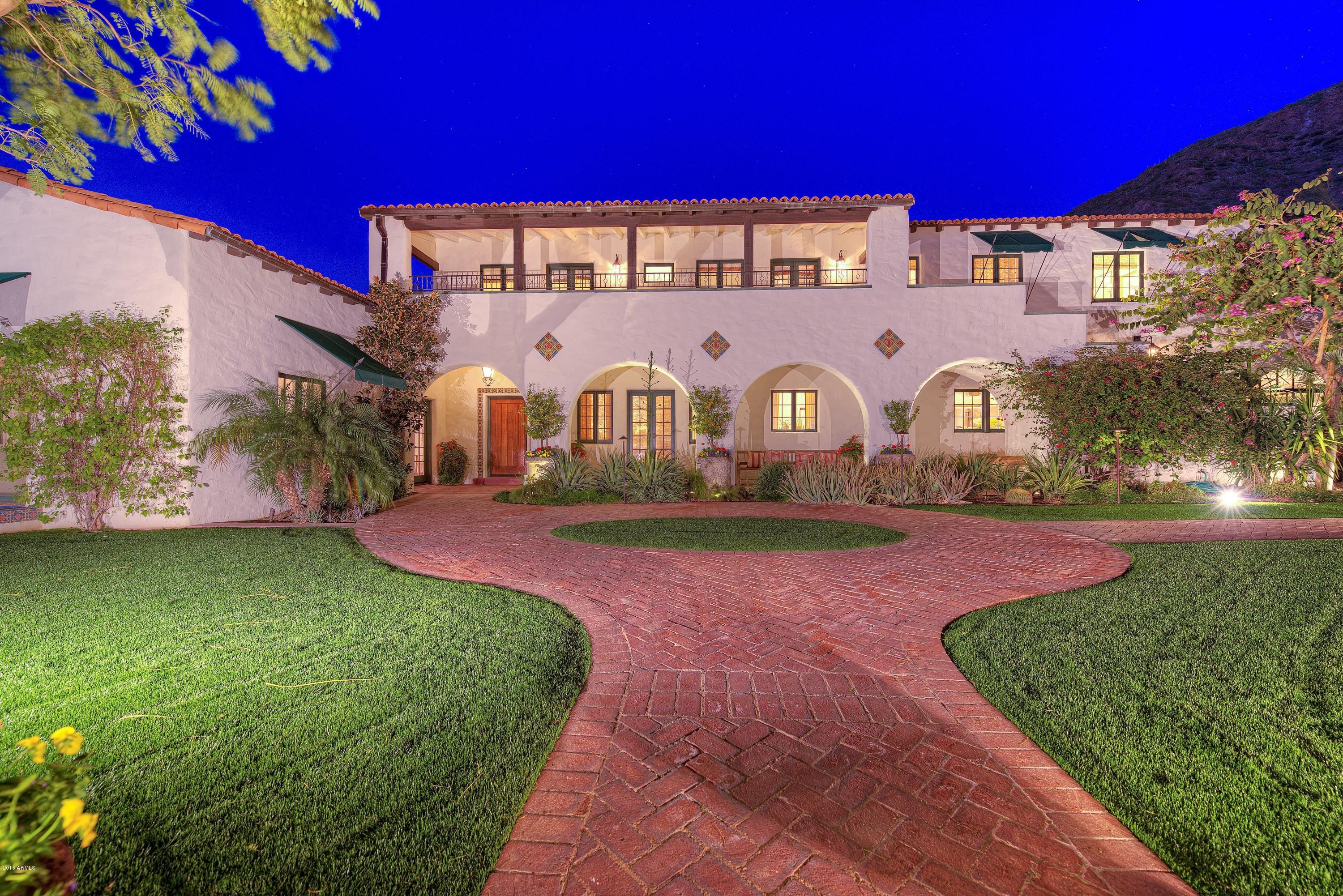 Hidden behind a beautiful gated entry
and up a trellised path of arched bougainvilleas lies one of our
city's treasured estates. Eye catching finish detail from the finest
local and national artisans. Sitting on the south slope of Camelback
Mountain, this 5 bedroom main house and 2 bedroom guest house property
is one to remember. Architectural and design highlights include: hand
plastered walls, extensive mesquite
mill work, custom iron lighting, Hope steel cased doors, hand crafted
Spanish concrete tiles throughout. Gourmet kitchen includes Vermont
Soap Stone, Spekva island and large butler's pantry. 5000 bottle wine
cellar accessed by stairs or elevator. Incredibly romantic and private
grounds provide the perfect setting for intimate or large scale
entertaining!